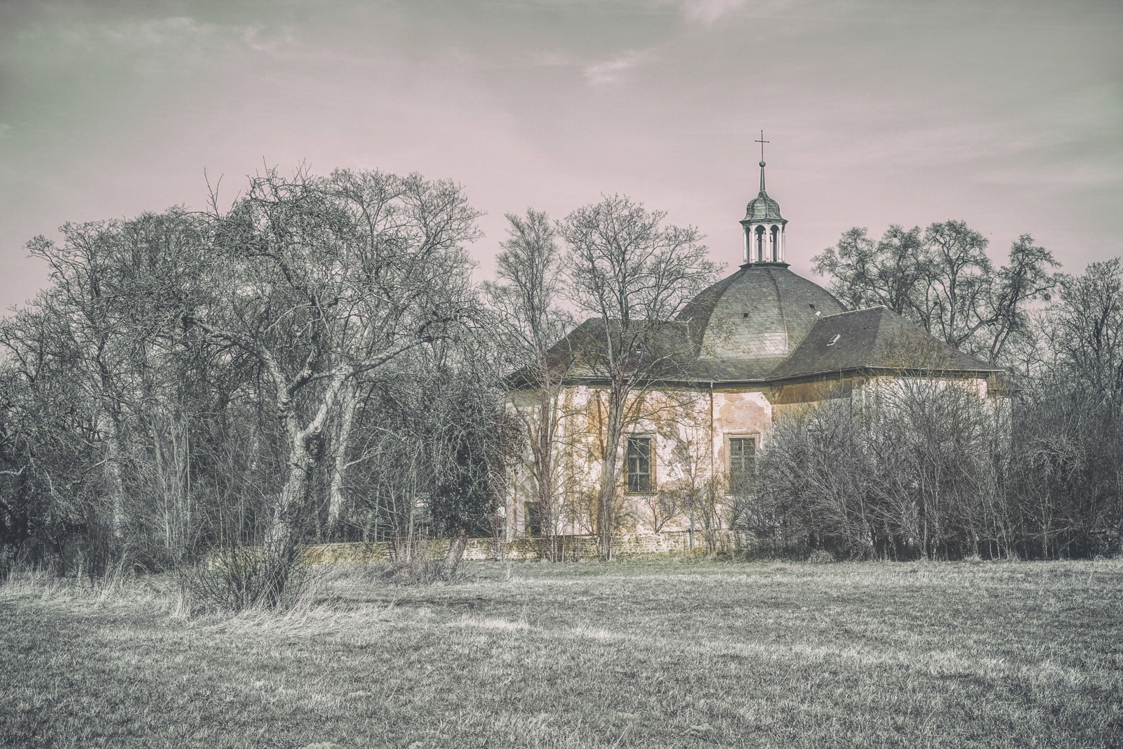 Back view to an abandoned church in bavaria in an artistic post production.