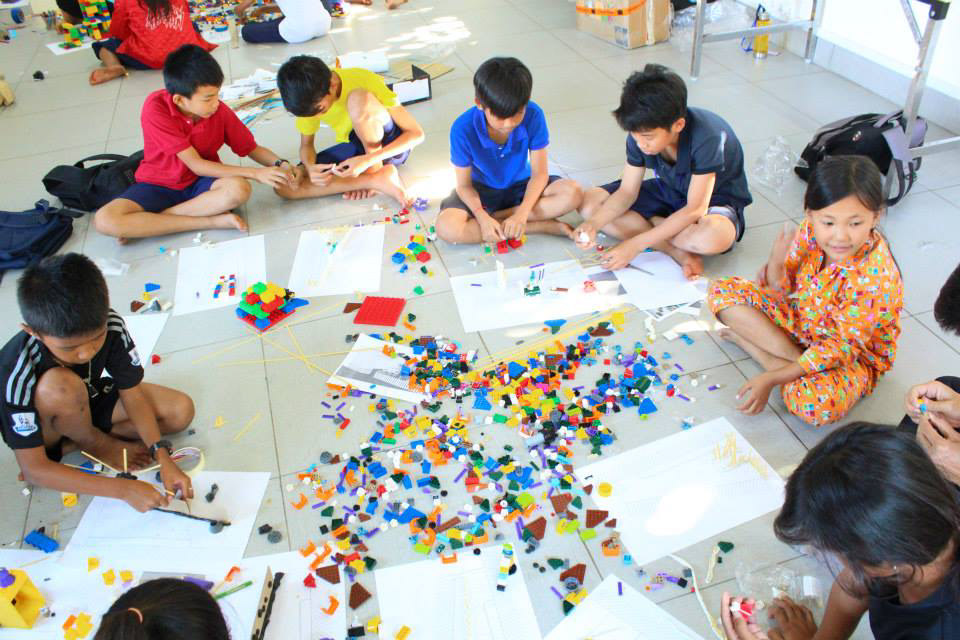 THE KIDS USING LEGO AS MOCK-UP MATERIAL FOR THE PLAYGROUND