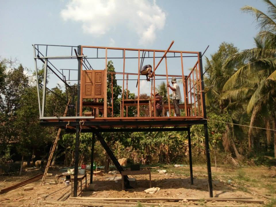 WORKING ON THE WOODEN STUDS AFTER THE STEEL FRAME IS COMPLETED