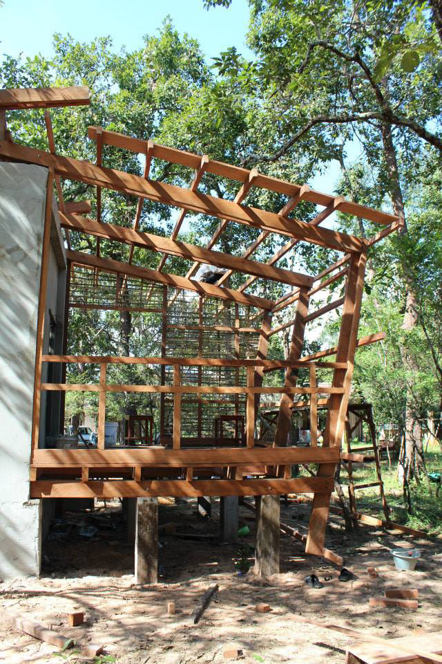 THE WOODEN STRUCTURE AND THE CONCRETE TOILET BLOCK IN THE CENTER