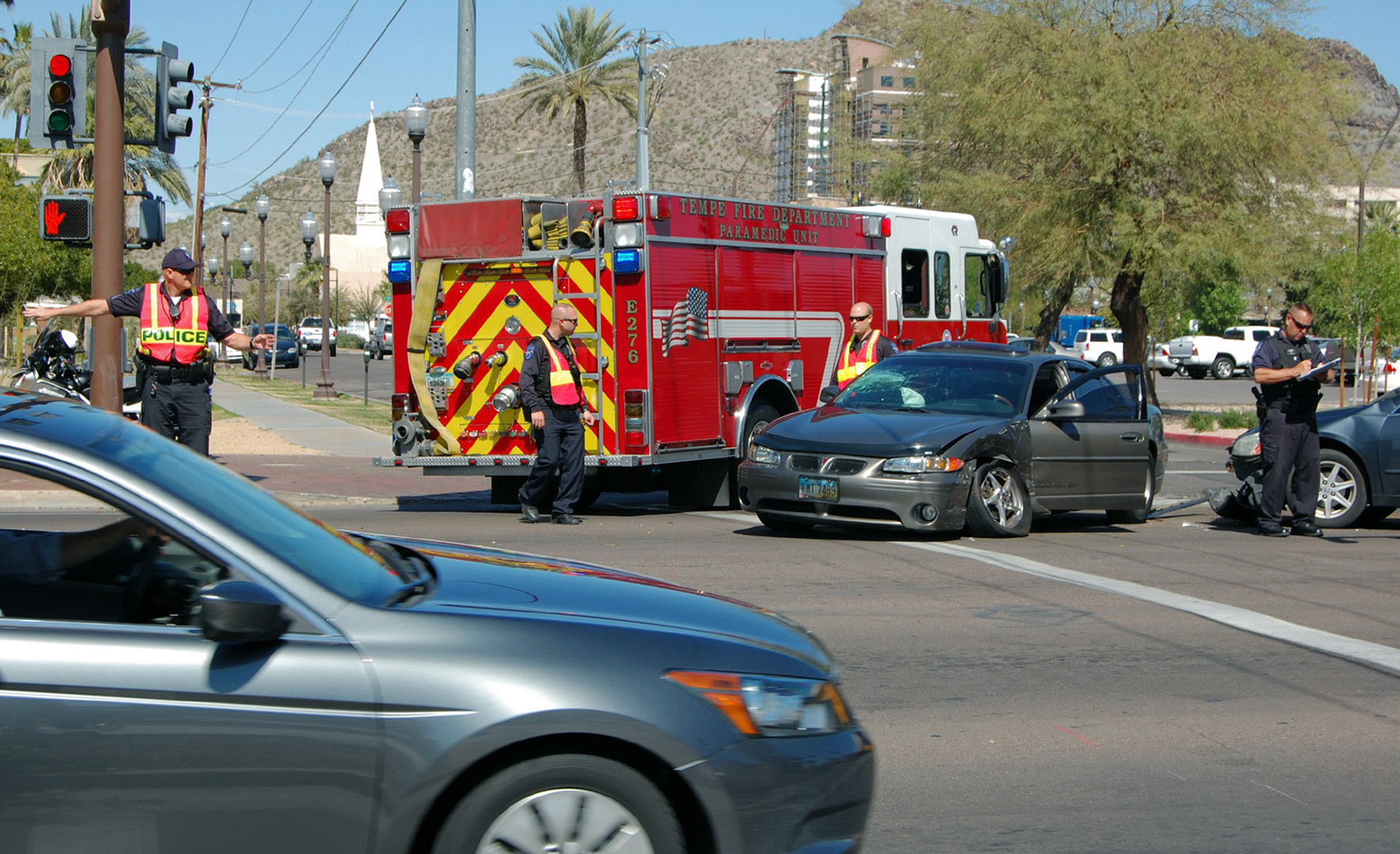 The Tempe Police and Fire Department clear the intersection on the northeast corner of University Drive and Mrytle Avenue after a two car collision obsructs the flow of traffic pictured Monday, March 4, 2013, in Tempe, Ariz. (JMCPhoto/Taylor Costello)