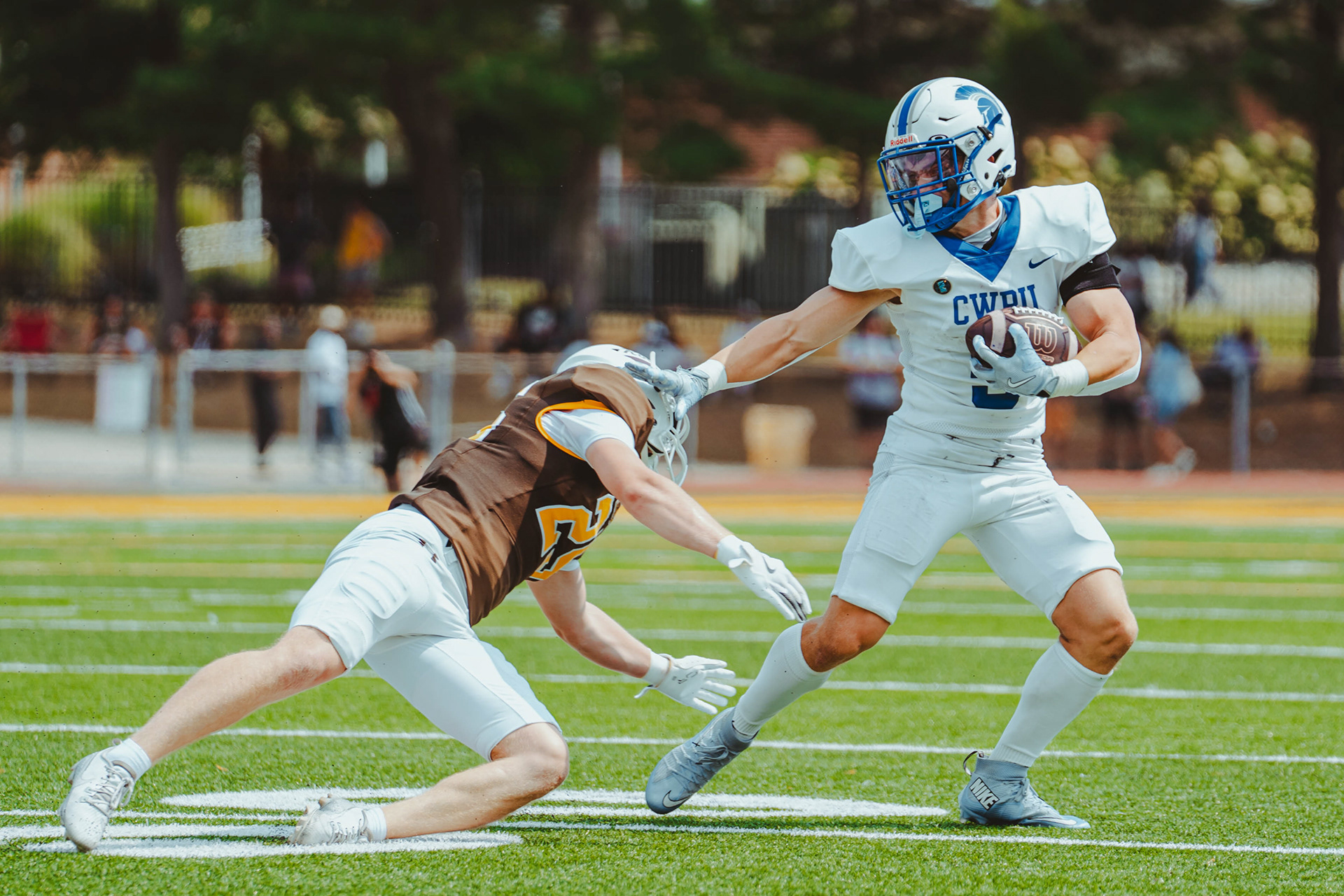 Case Western Reserve University wide receiver Will Stack (9) stiff-arms a Rowan University defender during a game at Coach Richard Wackar Stadium in Glassboro, N.J., on Sep. 6, 2025.