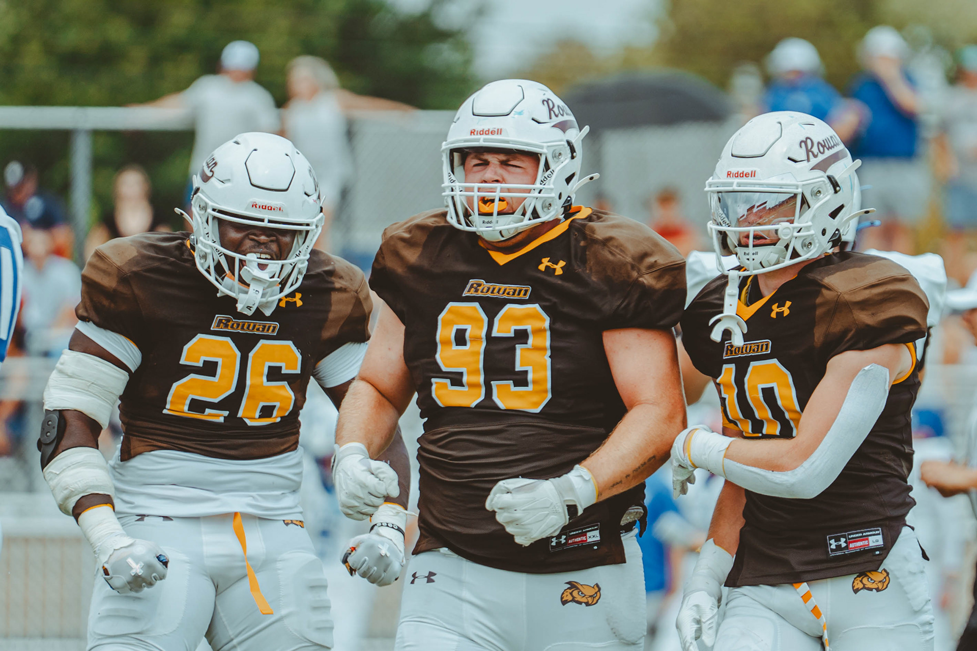 Rowan University defensive linemen Giaini Derameaux (26) and Carter Williams (93), and defensive back AJ Ryker (10) celebrate after a fourth-down stop against Case Western Reserve University at Coach Richard Wackar Stadium on Sept. 6, 2025.