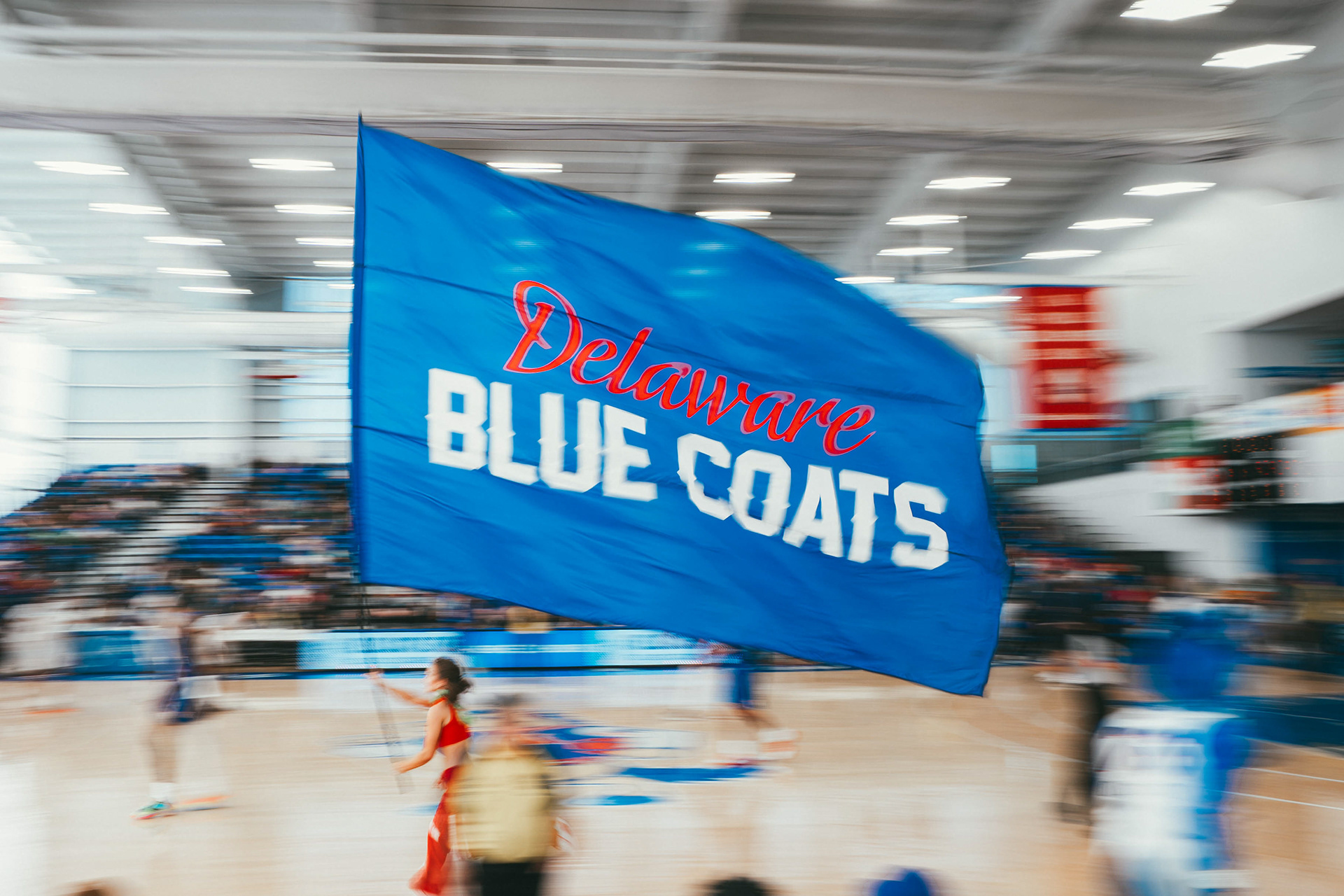Delaware Blue Coats Squad 76 runs a flag across the court during a second-quarter timeout as the Blue Coats host the Grand Rapids Gold at Chase Fieldhouse on March 2, 2026.