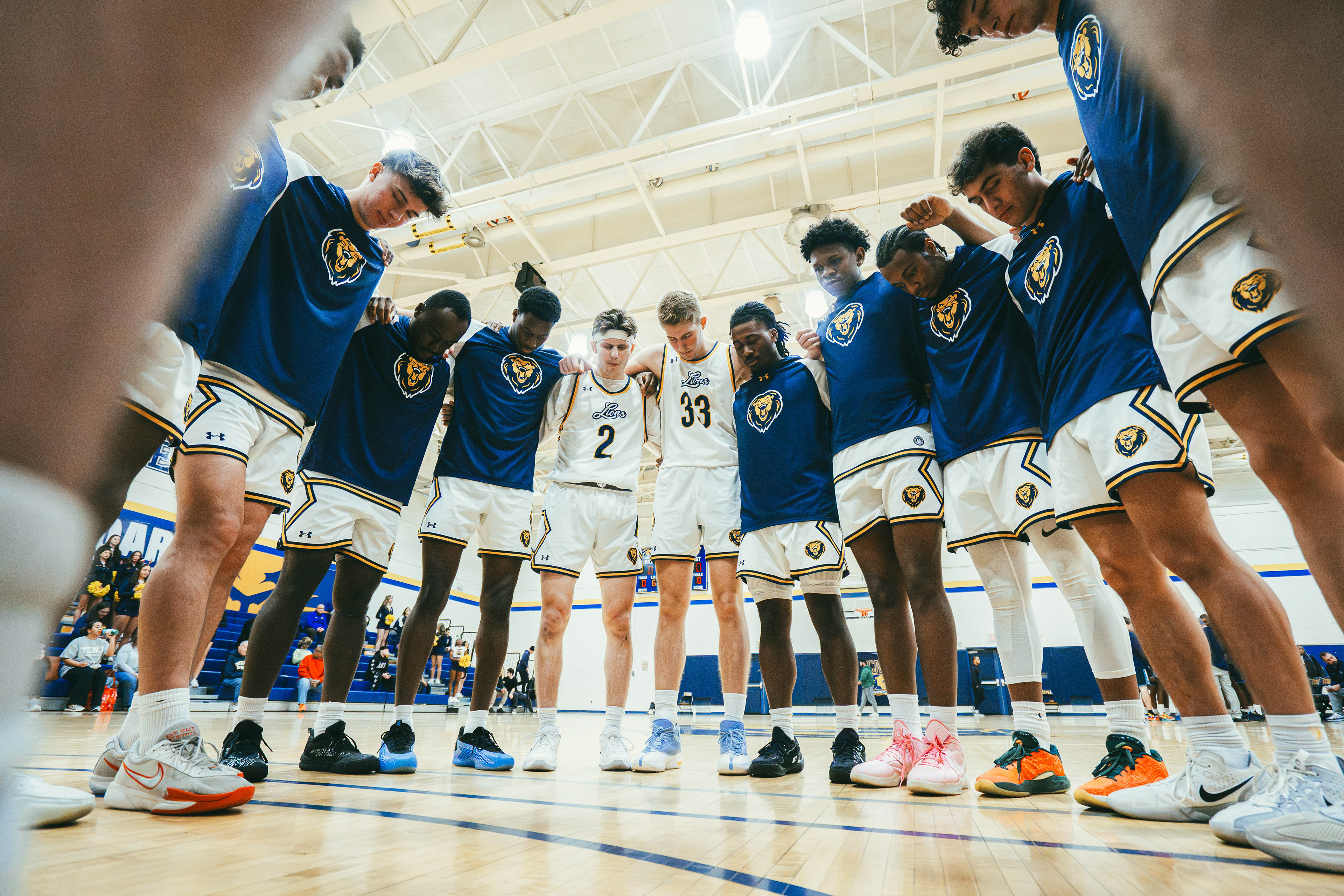 The College of New Jersey players pray before a game against Kean University at Packer Hall in Ewing, N.J., on Dec. 6, 2025.
