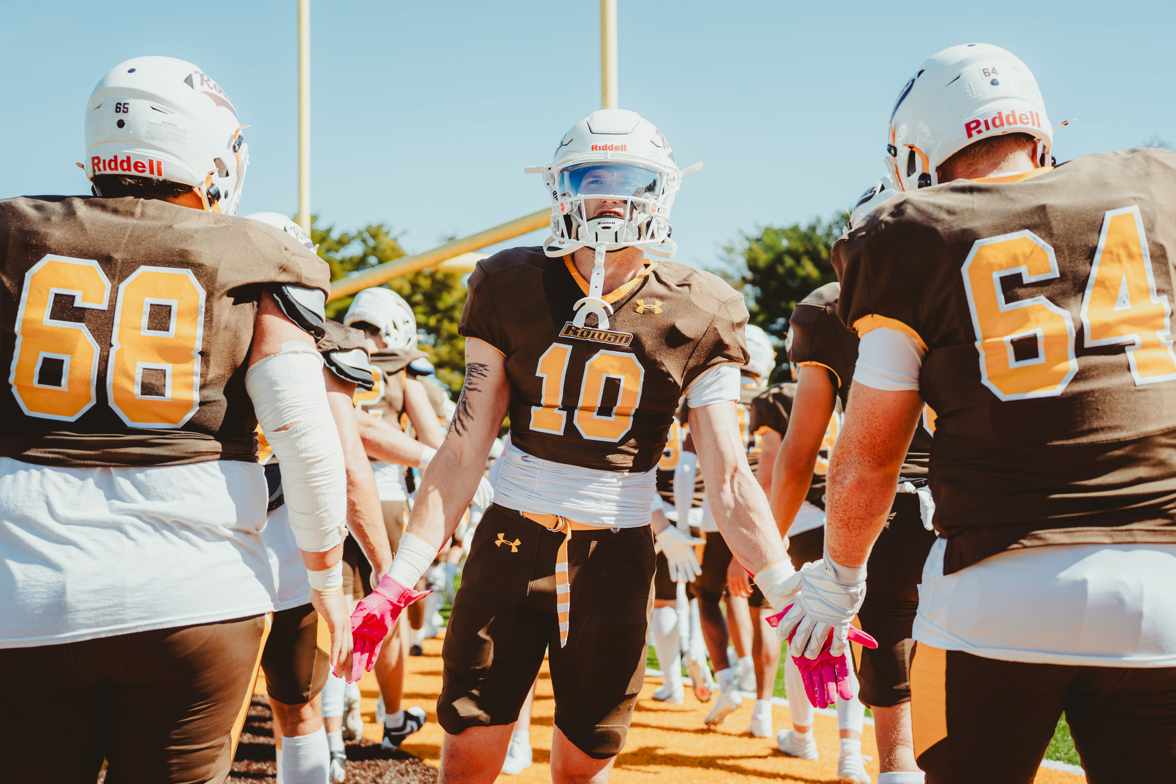 Rowan University defensive back AJ Ryker (10) high-fives teammates prior to a game against Christopher Newport University at Coach Richard Wackar Stadium in Glassboro, N.J., on Oct. 4, 2025.