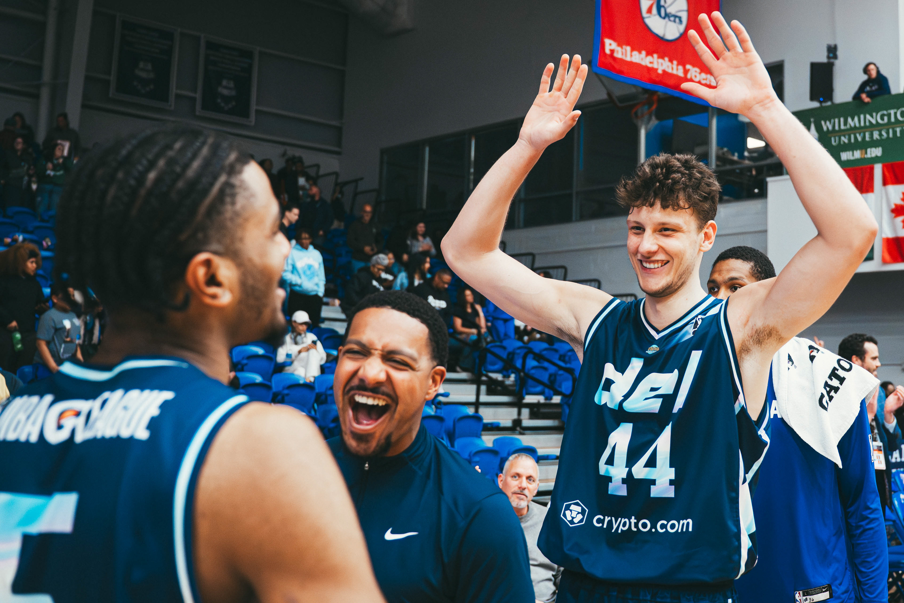 Delaware Blue Coats forward Igor Miličić Jr. (44), guard Kellen Tynes (5), and assistant coach Micah Fraction celebrate after an overtime victory against the Capital City Go-Go at Chase Fieldhouse in Wilmington, DE., on Mar. 28, 2026.