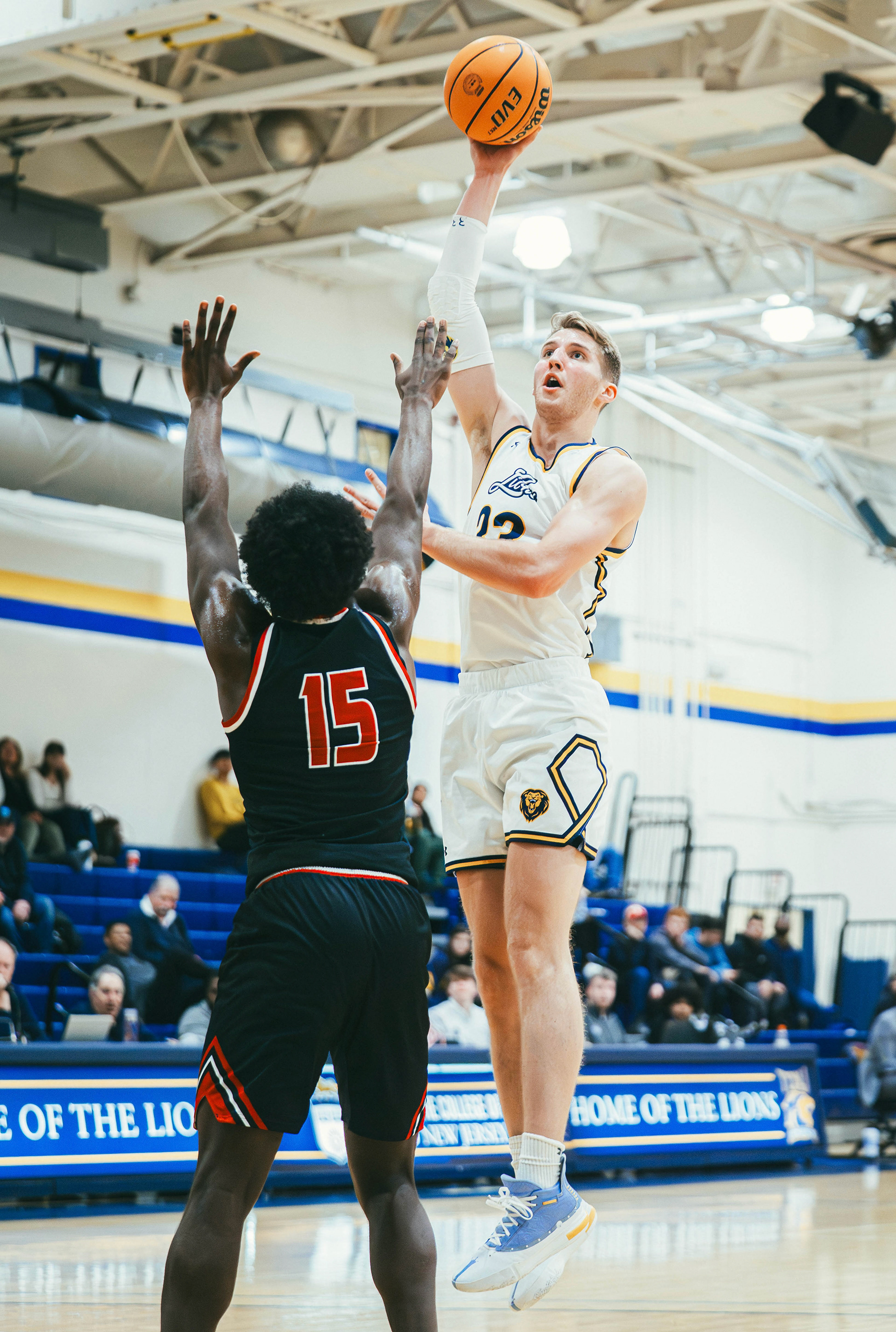 The College of New Jersey forward Matthew Solomon (33) shoots over Rutgers-Newark center Will Ndio (15) during a game at Packer Hall in Ewing, N.J., on Jan. 10, 2026.