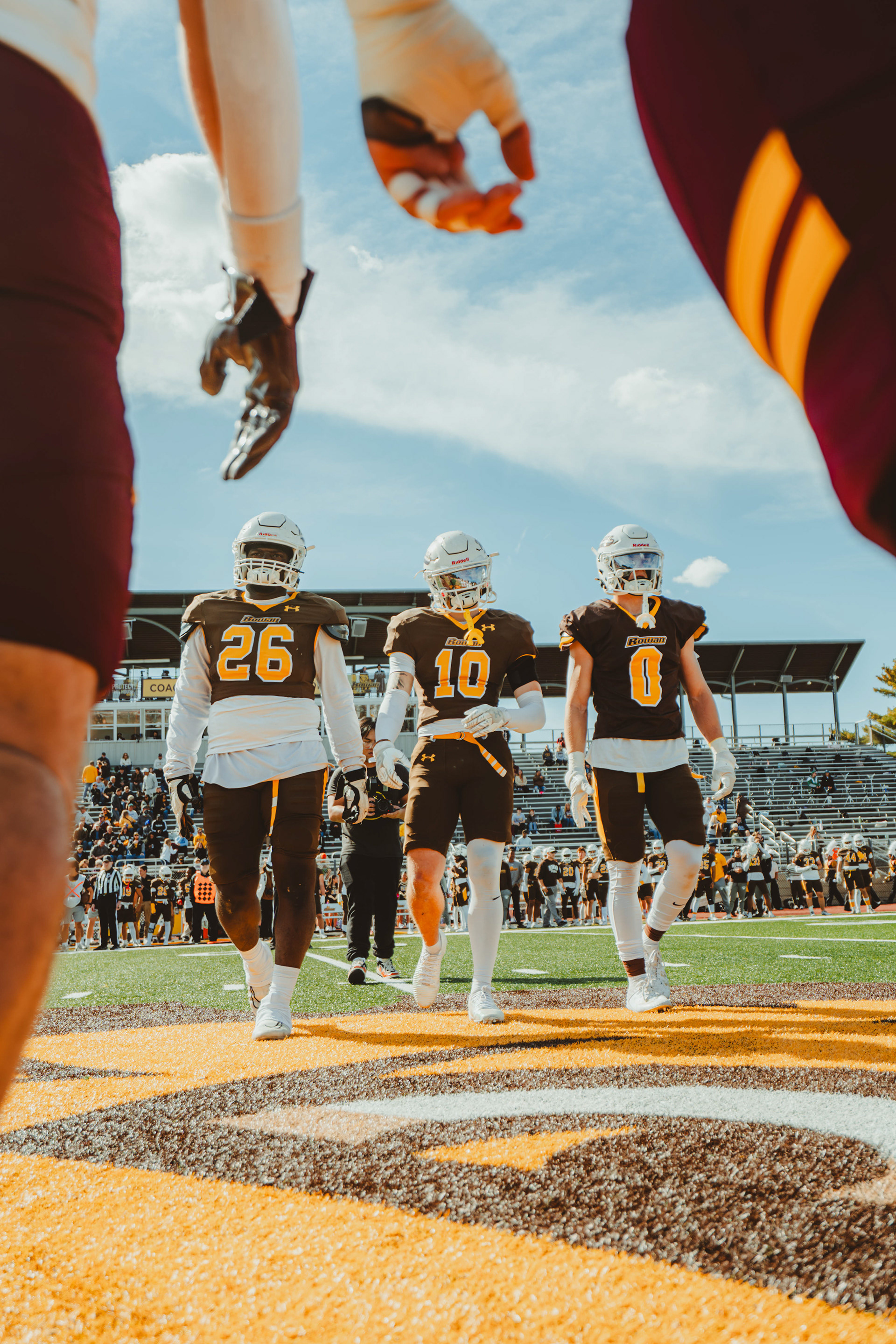 Rowan University defensive lineman Giaini Derameaux (26), defensive back AJ Ryker (10) and wide receiver Shane Martin (0) meet Salisbury University during the pregame captains meeting prior to a game at Coach Richard Wackar Stadium in Glassboro, N.J., on Oct. 25, 2025.