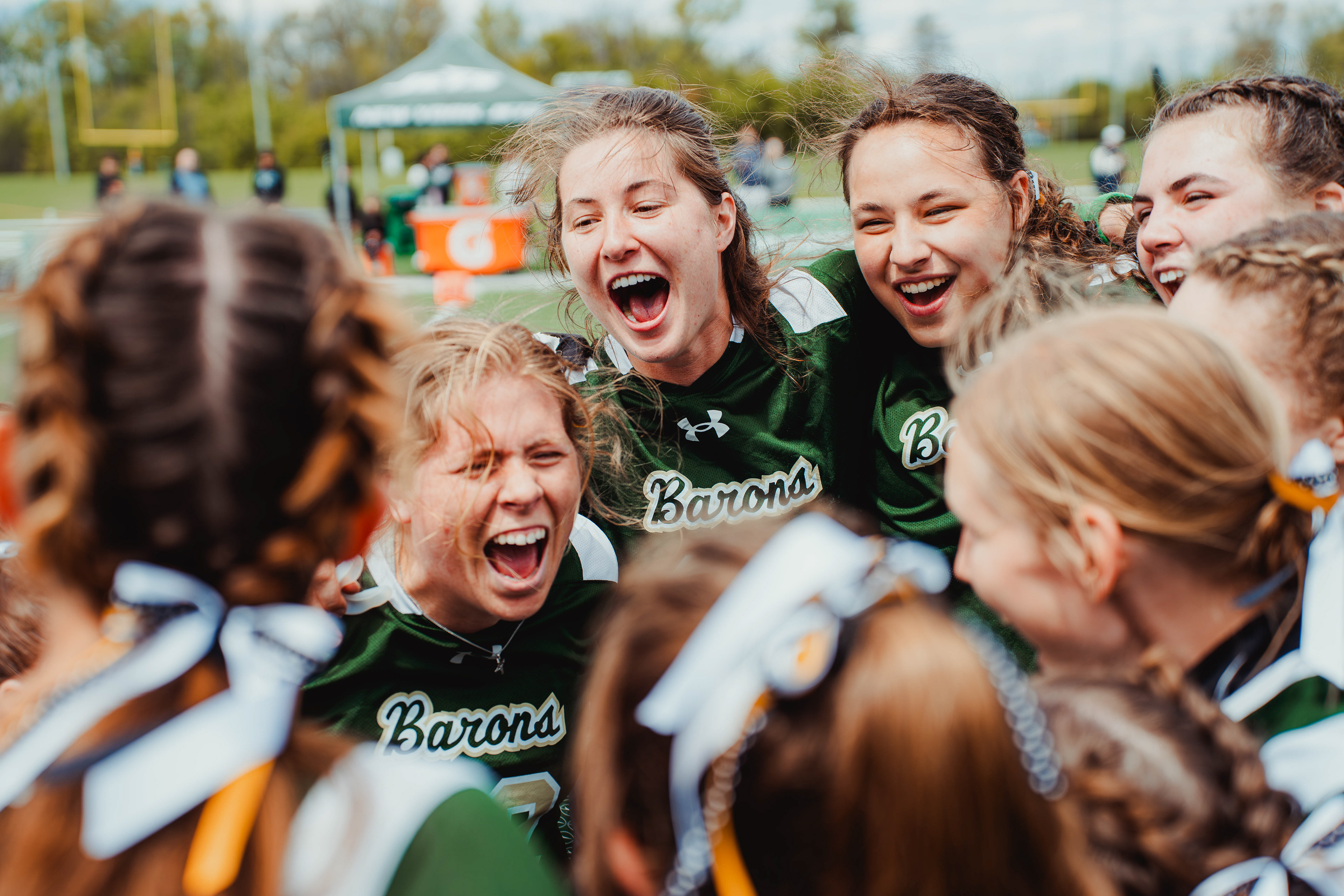 Franciscan Barons women’s flag football team huddle and celebrate before a game against St. John’s University at the New York Jets Training Facility in Florham Park, N.J. during the Jets ECAC Women’s Flag Football Tournament on May 2, 2026.