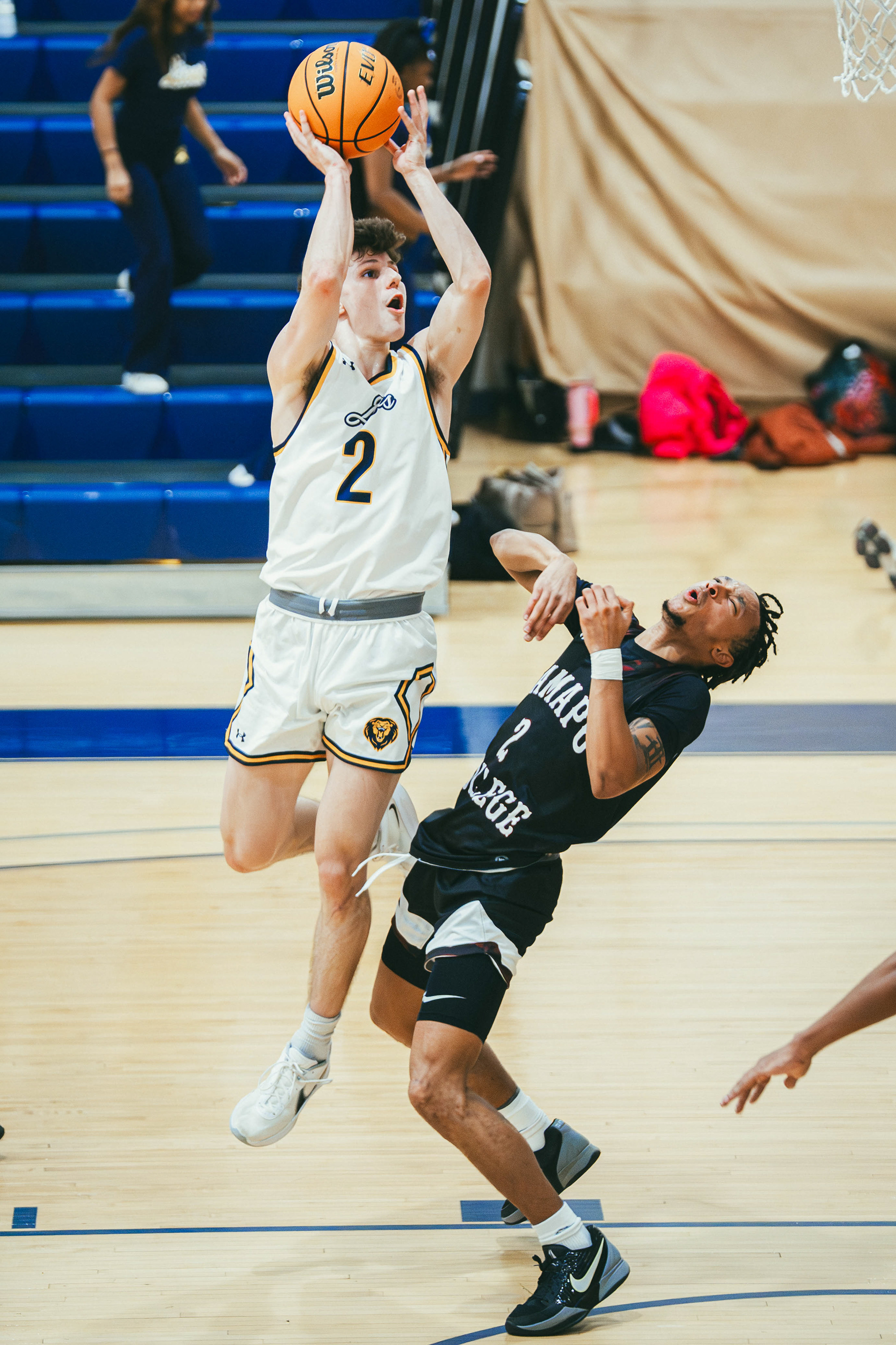 The College of New Jersey guard Nick Koch (2) attempts a shot over Ramapo College of New Jersey guard Elijah Barlow (2) during a game at Packer Hall in Ewing, N.J., on Dec. 13, 2025.