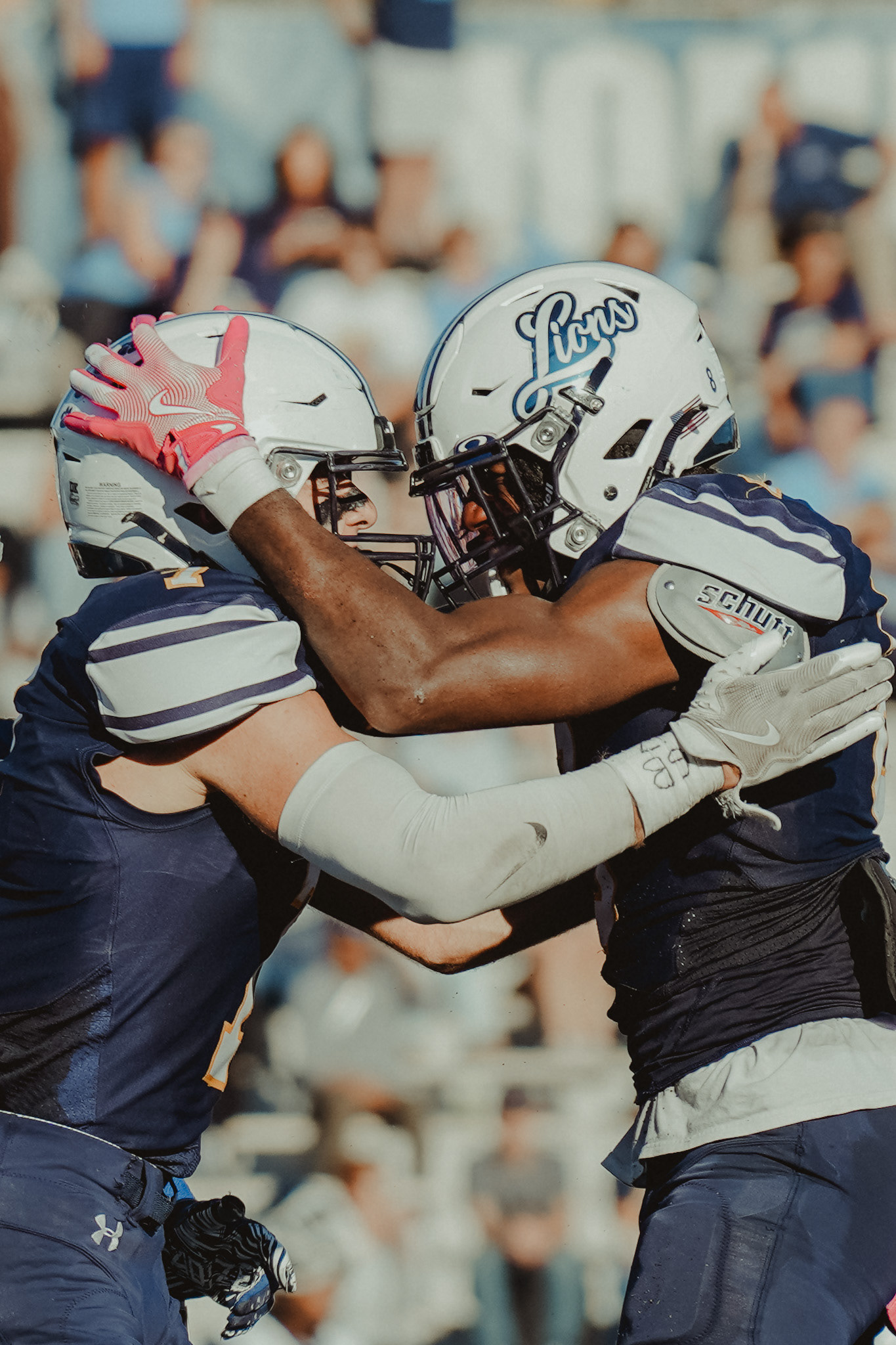 The College of New Jersey players celebrate after a fourth-down turnover against Kean University at Lions Stadium in Ewing, N.J., on Oct. 19, 2024.