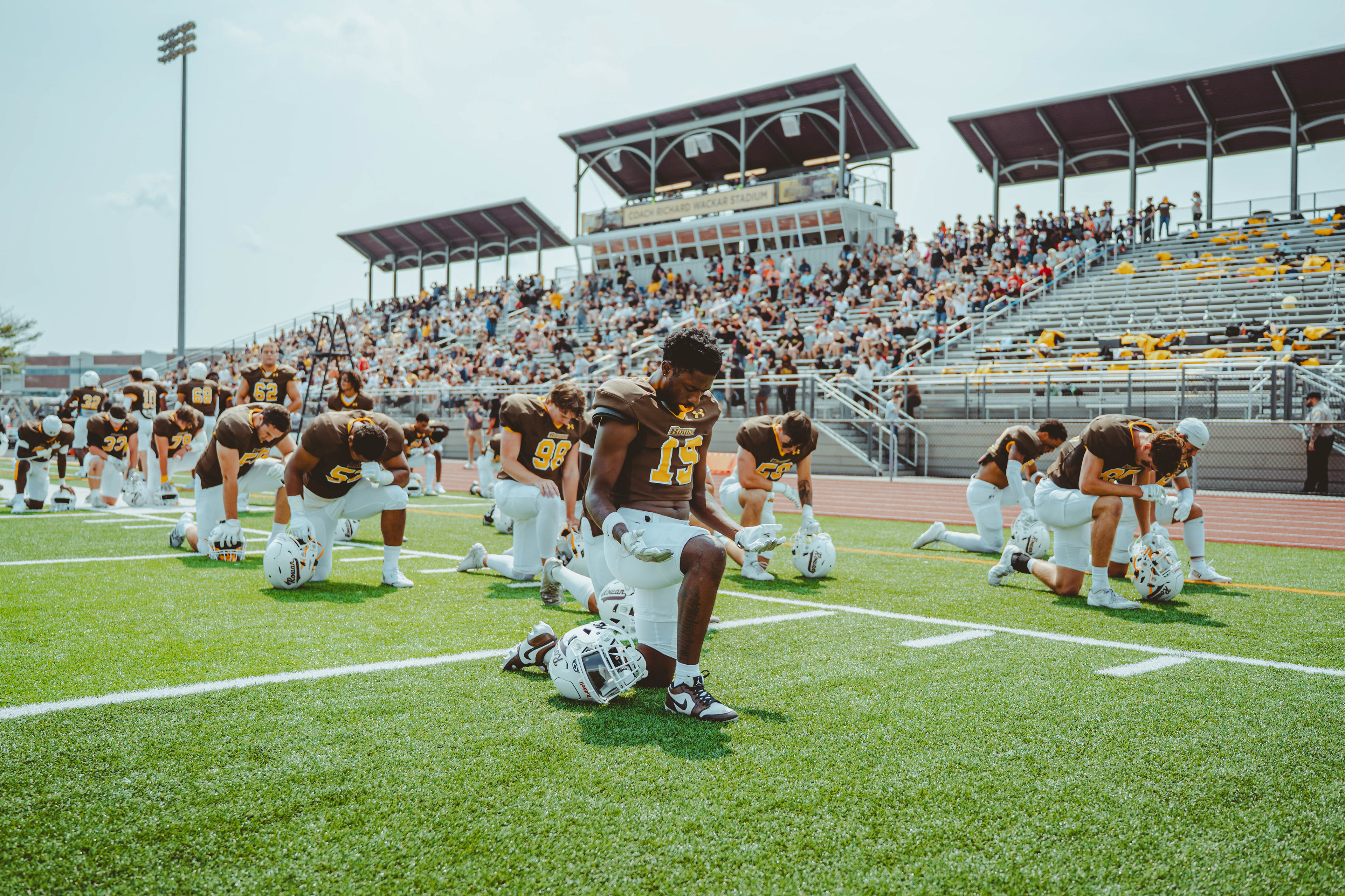  Rowan University football players pray together prior to kickoff before a game against Case Western Reserve University at Coach Richard Wackar Stadium in Glassboro, N.J., on Sep. 6, 2025. 