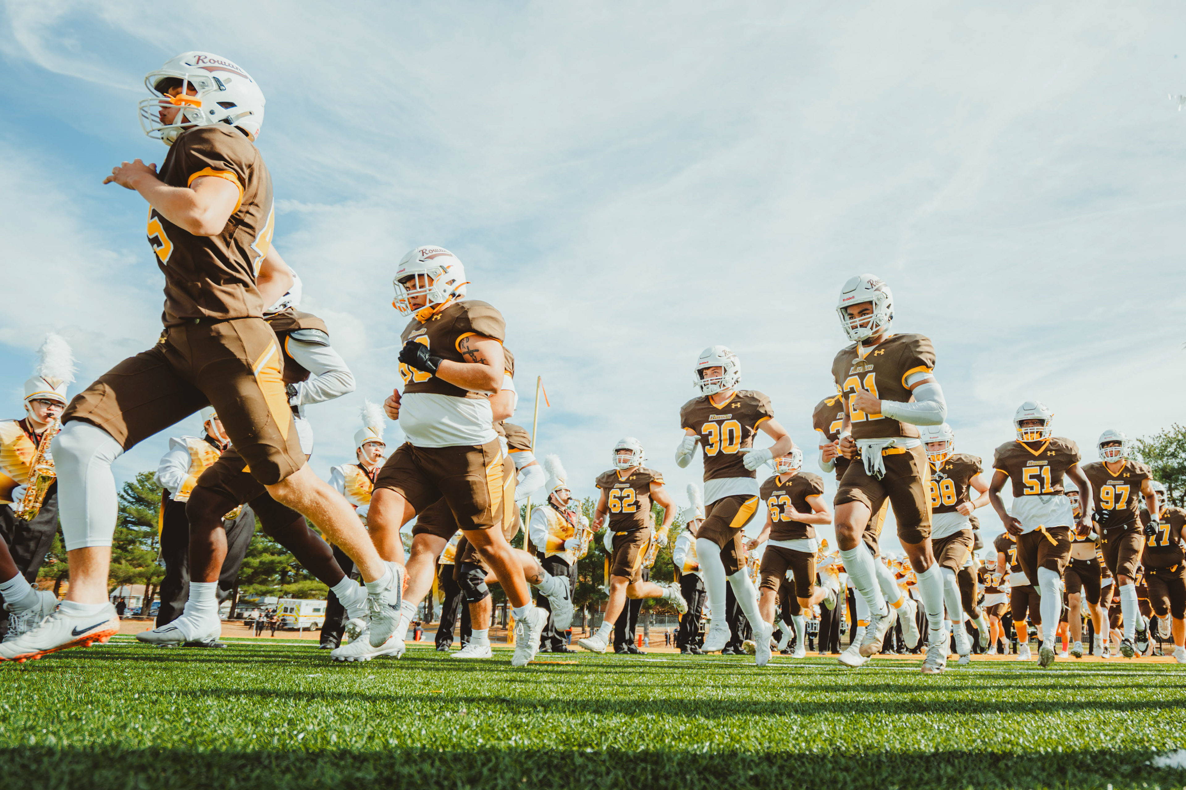 The Rowan University football team takes the field before a game against Salisbury University at Coach Richard Wackar Stadium in Glassboro, N.J., on Oct. 25, 2025.