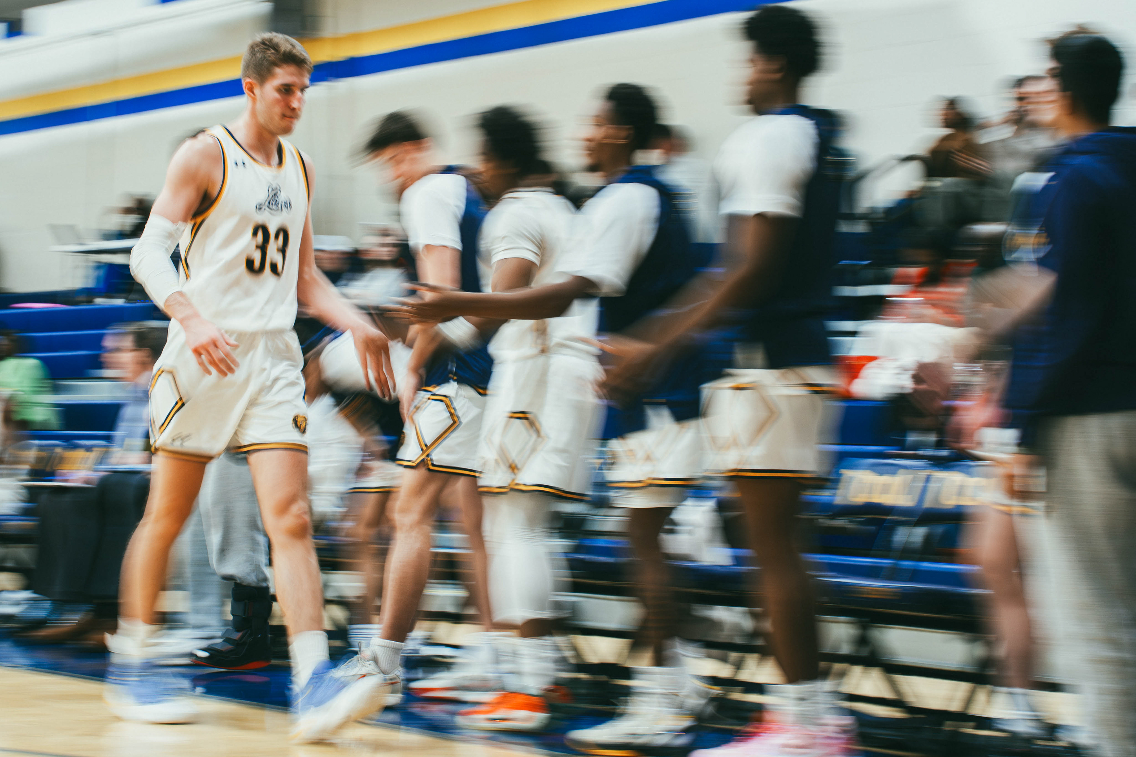 The College of New Jersey forward Matthew Solomon (33) high fives teammates during a game against Rutgers-Newark at Packer Hall in Ewing, N.J., on Jan. 10, 2026.