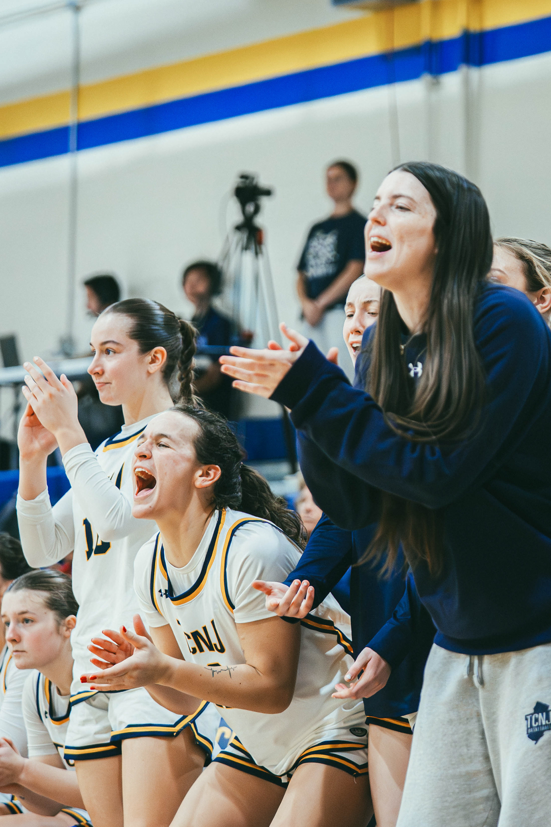 The College of New Jersey players celebrate after a three-point basket against Kean University at Packer Hall in Ewing, N.J., on Dec. 6, 2025.