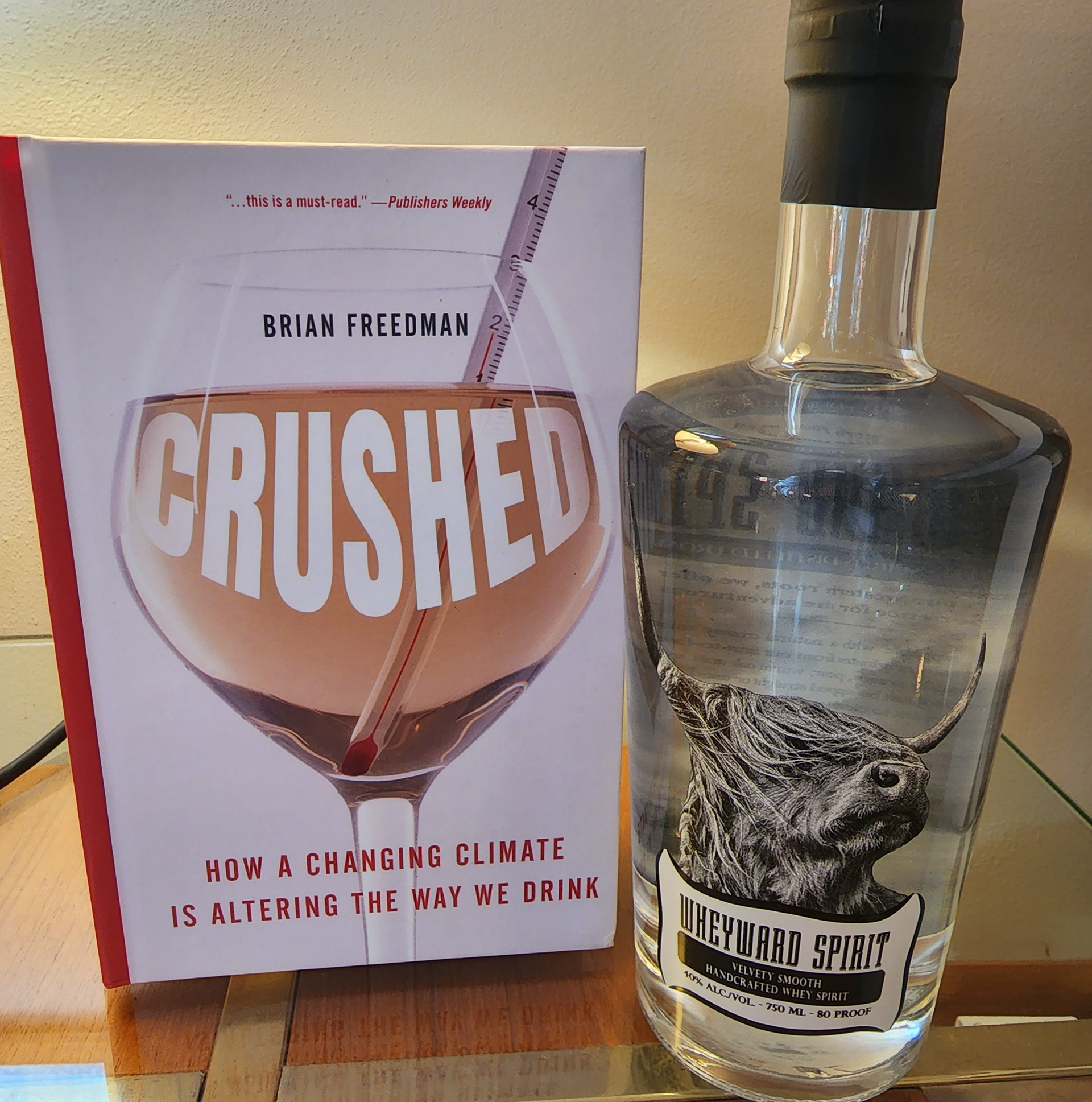 Crushed: How a Changing Climate Is Altering the Way We Drink book and a bottle of Wheyward Spirit