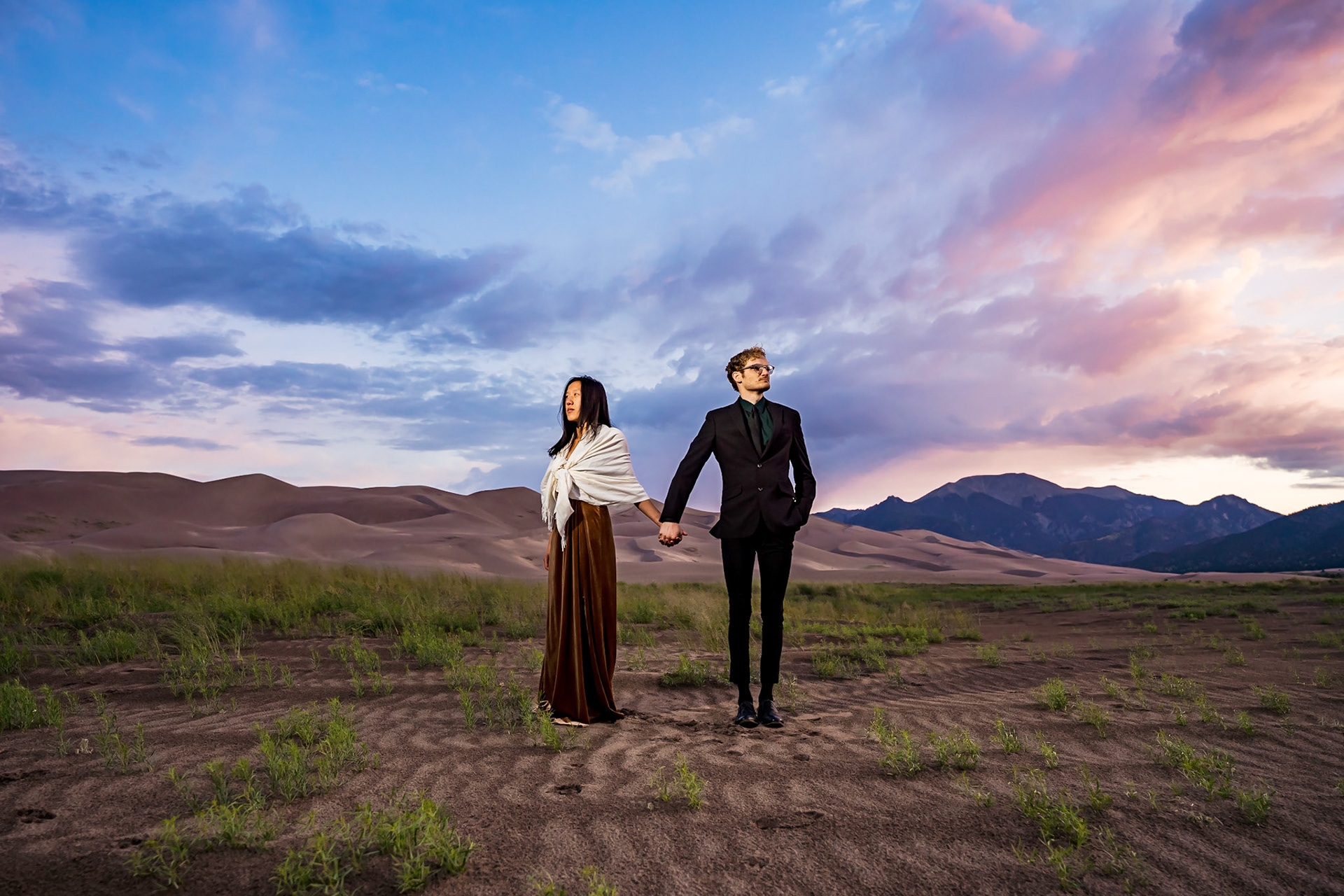 Adventure engagement session at the Great Sand Dunes in Colorado. Camping trip with husky dog. Sunrise and Sunset photos on the Dunes.