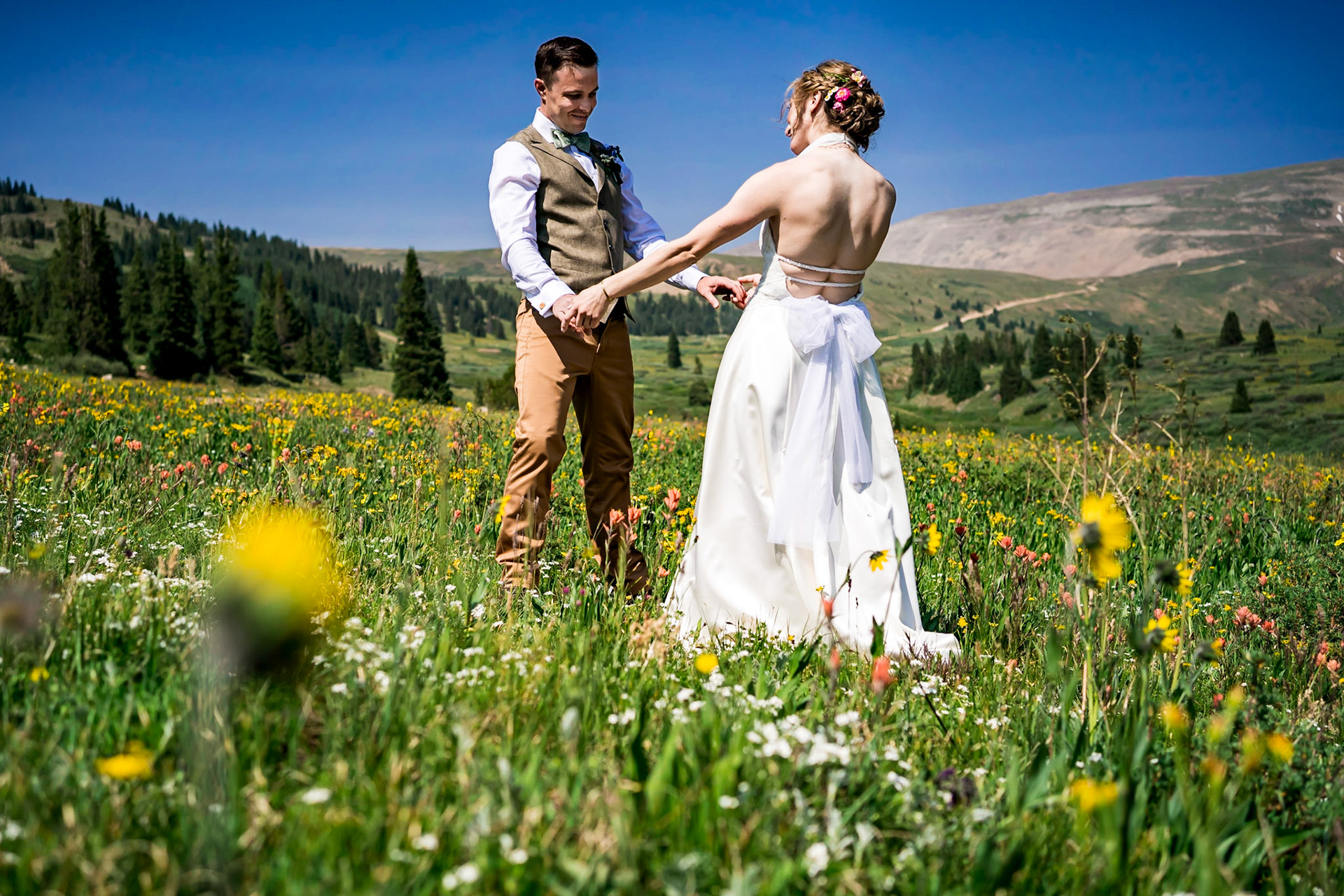 Wildflower themed wedding in Leadville Colorado. Reception at FREIGHT. Colorful nighttime portraits. Rocky Mountain Beverage Burros.