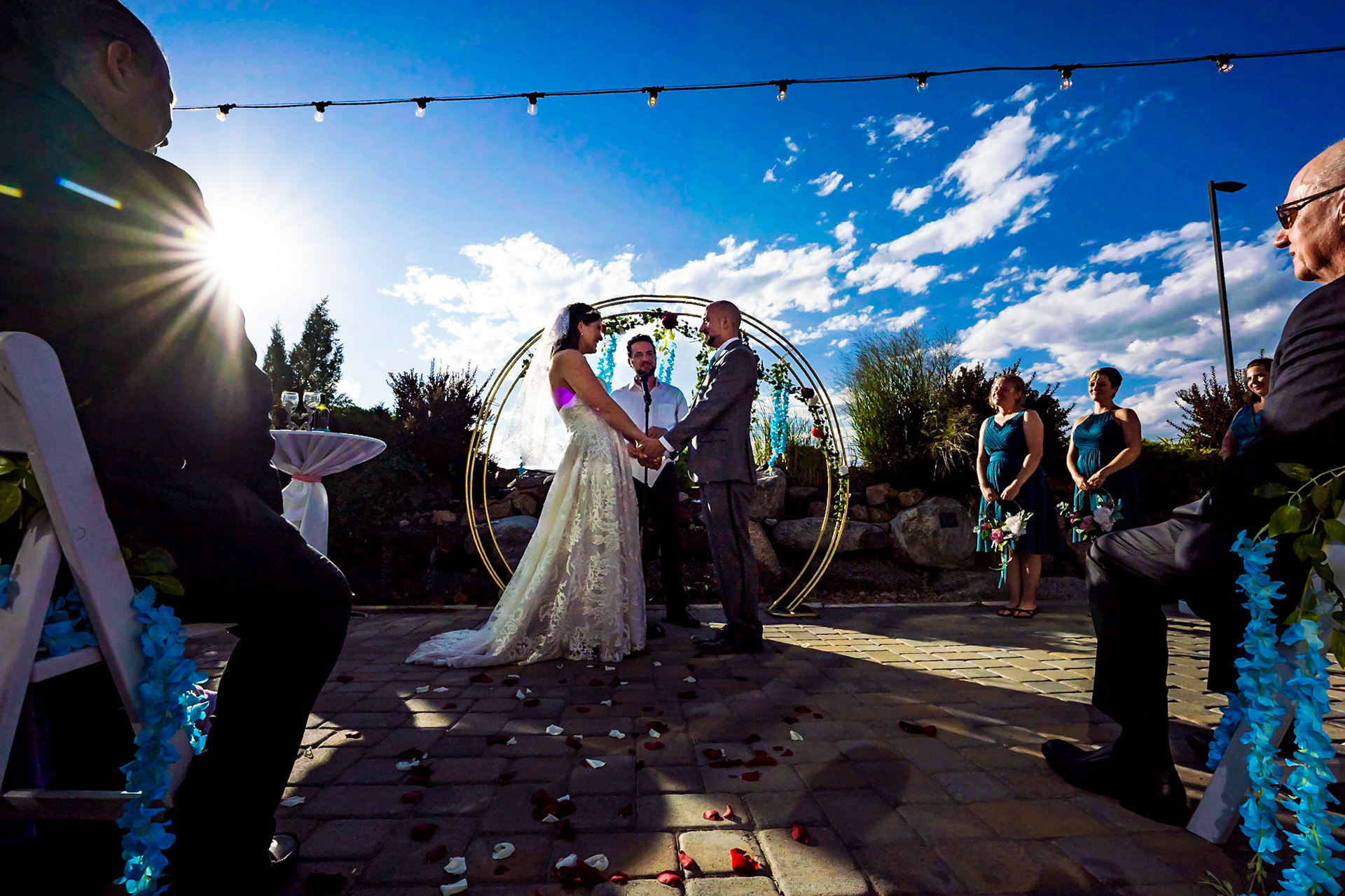 Colorful wedding at Wedgewood Ashely Ridge in Colorado. Getting ready at home. First look and portraits in the park. Flower man, couples portraits with bubbles.