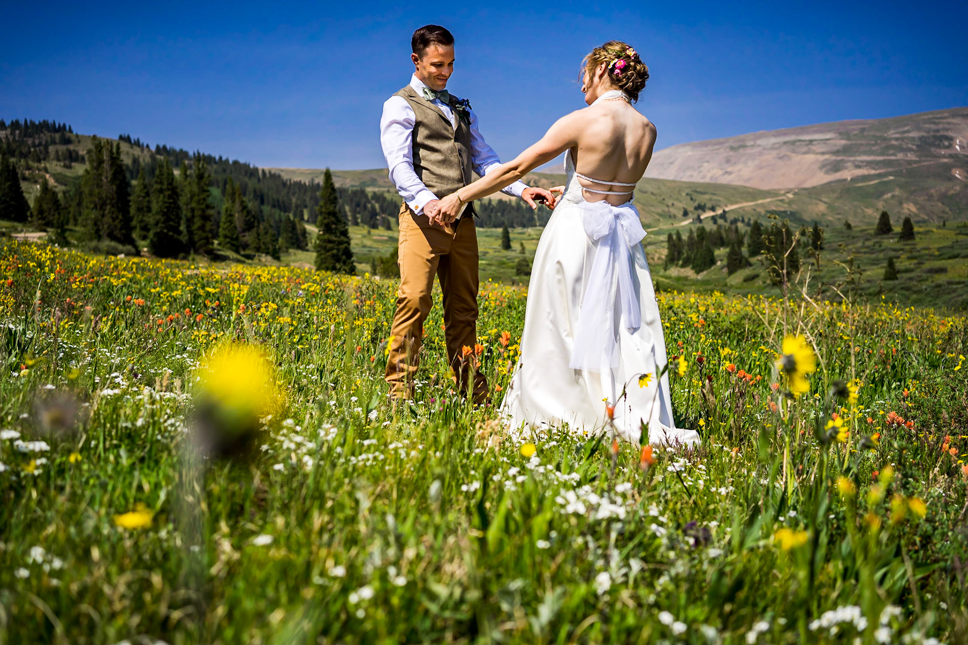 Wildflower themed wedding in Leadville Colorado. Reception at FREIGHT. Colorful nighttime portraits. Rocky Mountain Beverage Burros.