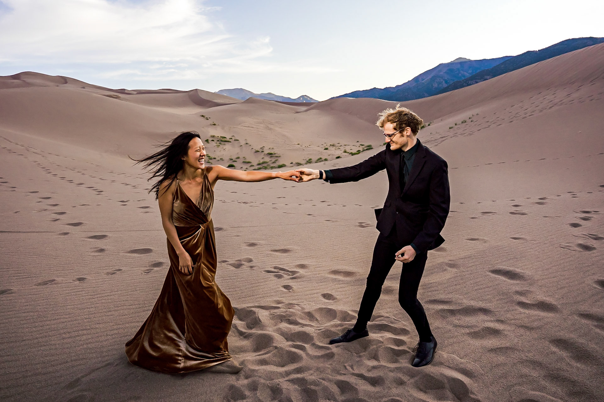 Adventure engagement session at the Great Sand Dunes in Colorado. Camping trip with husky dog. Sunrise and Sunset photos on the Dunes.