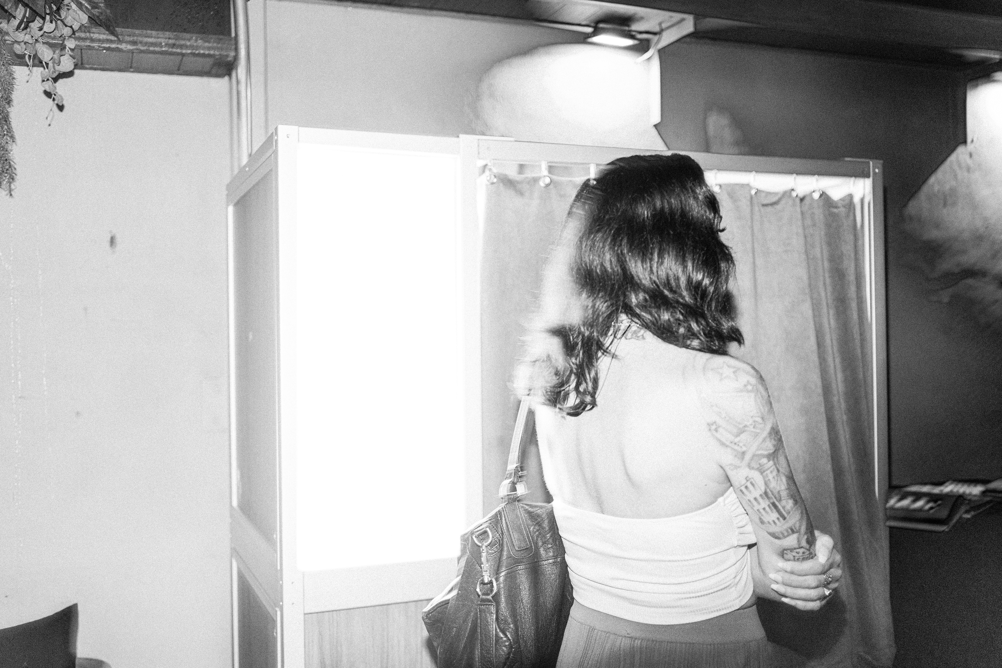 Girl waiting in line at NYC bar, photographed on film by photographer Lana Dubkova