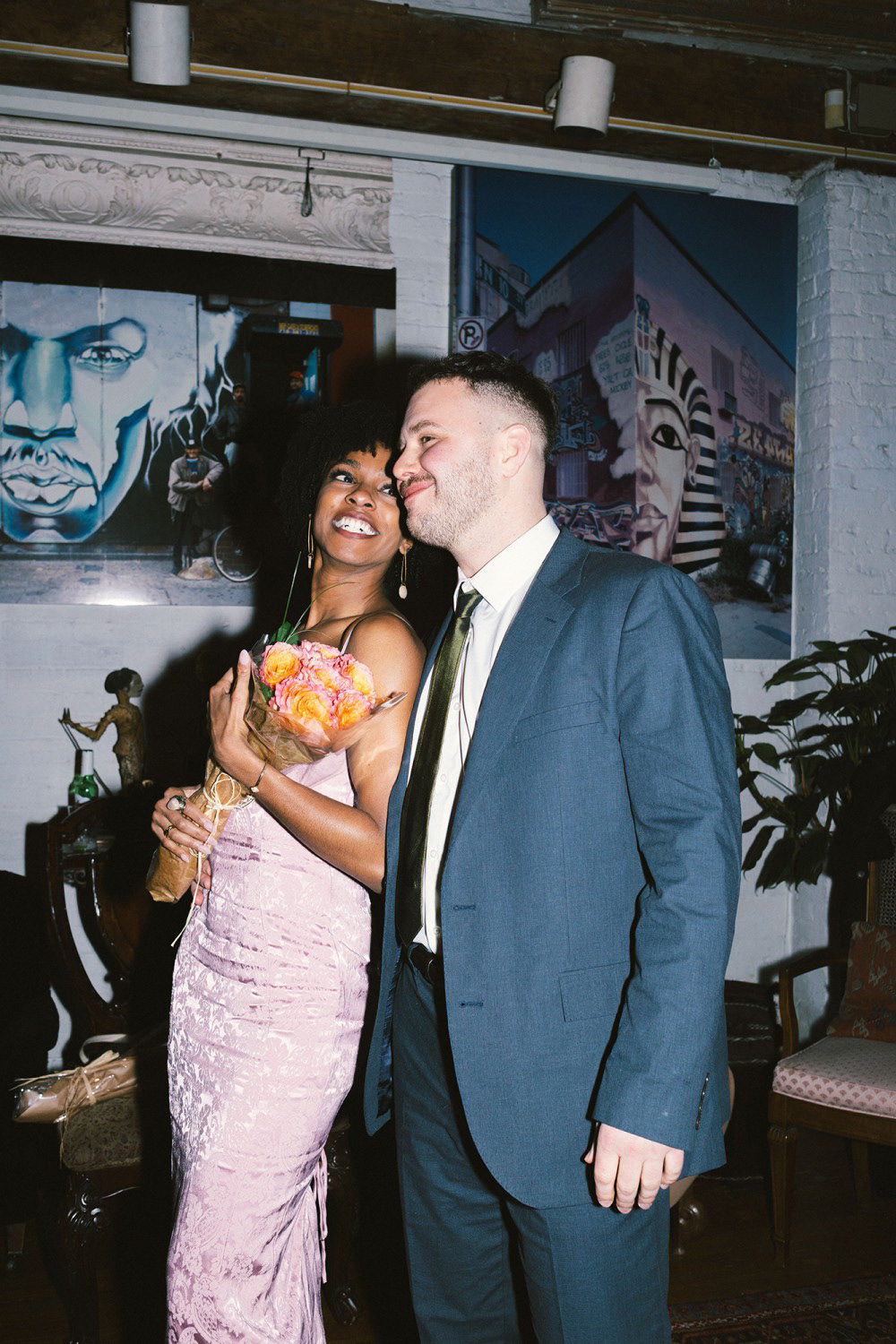 Couple looking at each other and smiling, NYC engagement photographed on film by photographer Lana Dubkova