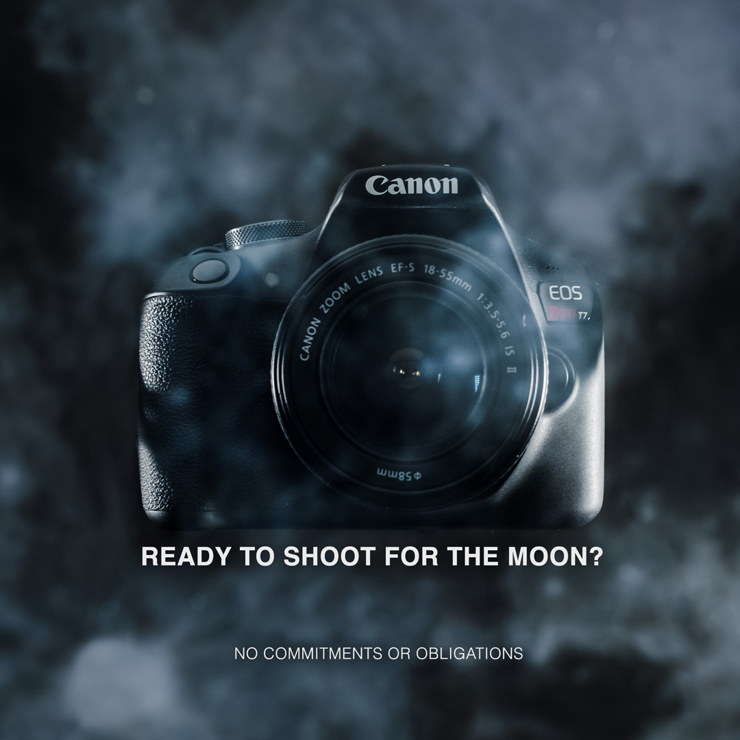 Canon EOS Rebel T7 taking an image of its own reflection while looking through the window of a spacecraft orbiting the moon, the surface of the moon in the background. Overlay text reads: Ready to shoot for the moon? No commitments or obligations.