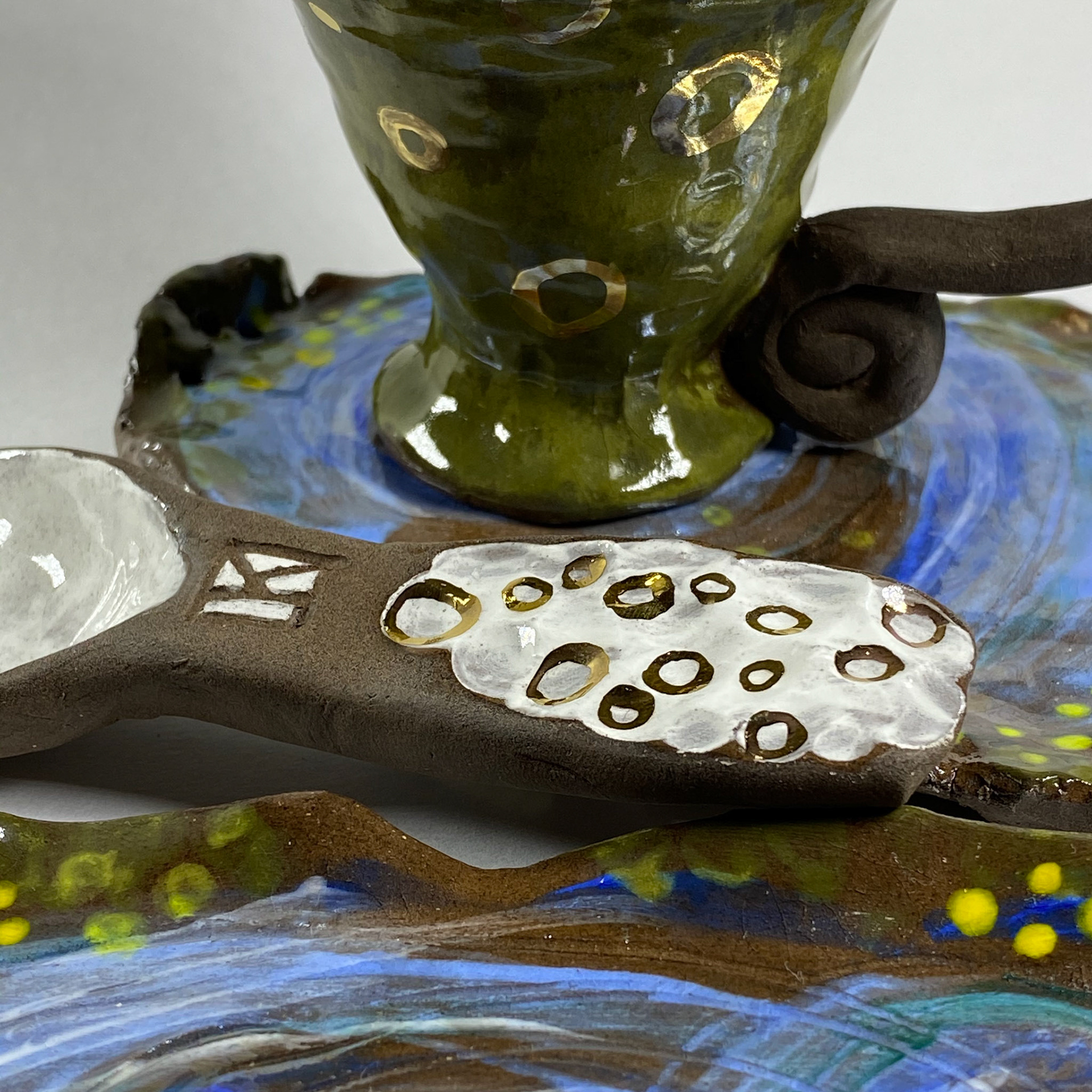 Elegant swamp teacup, saucer, and spoo