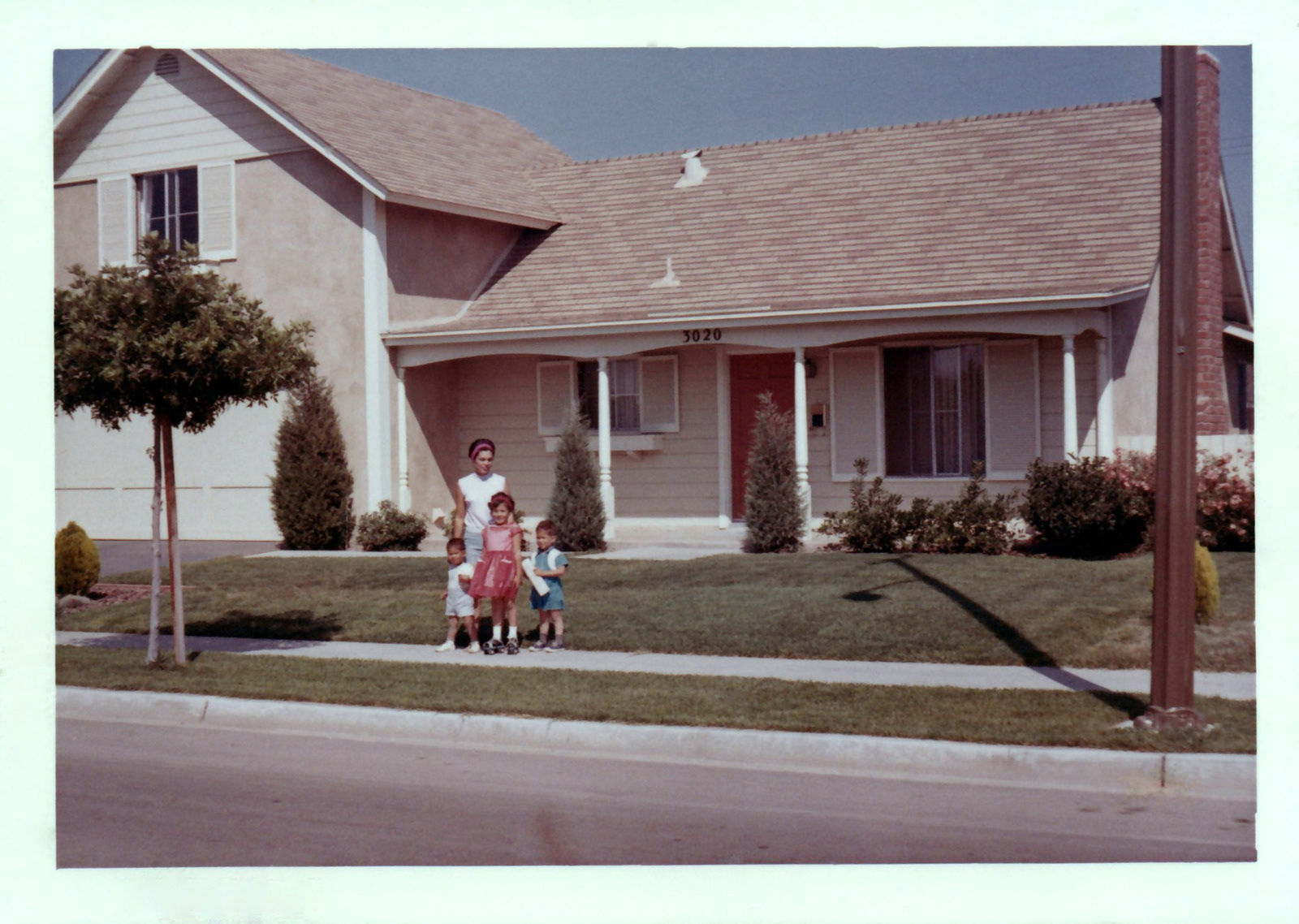 Fred takes a picture of his Family in front of their Costa Mesa house, 1960's