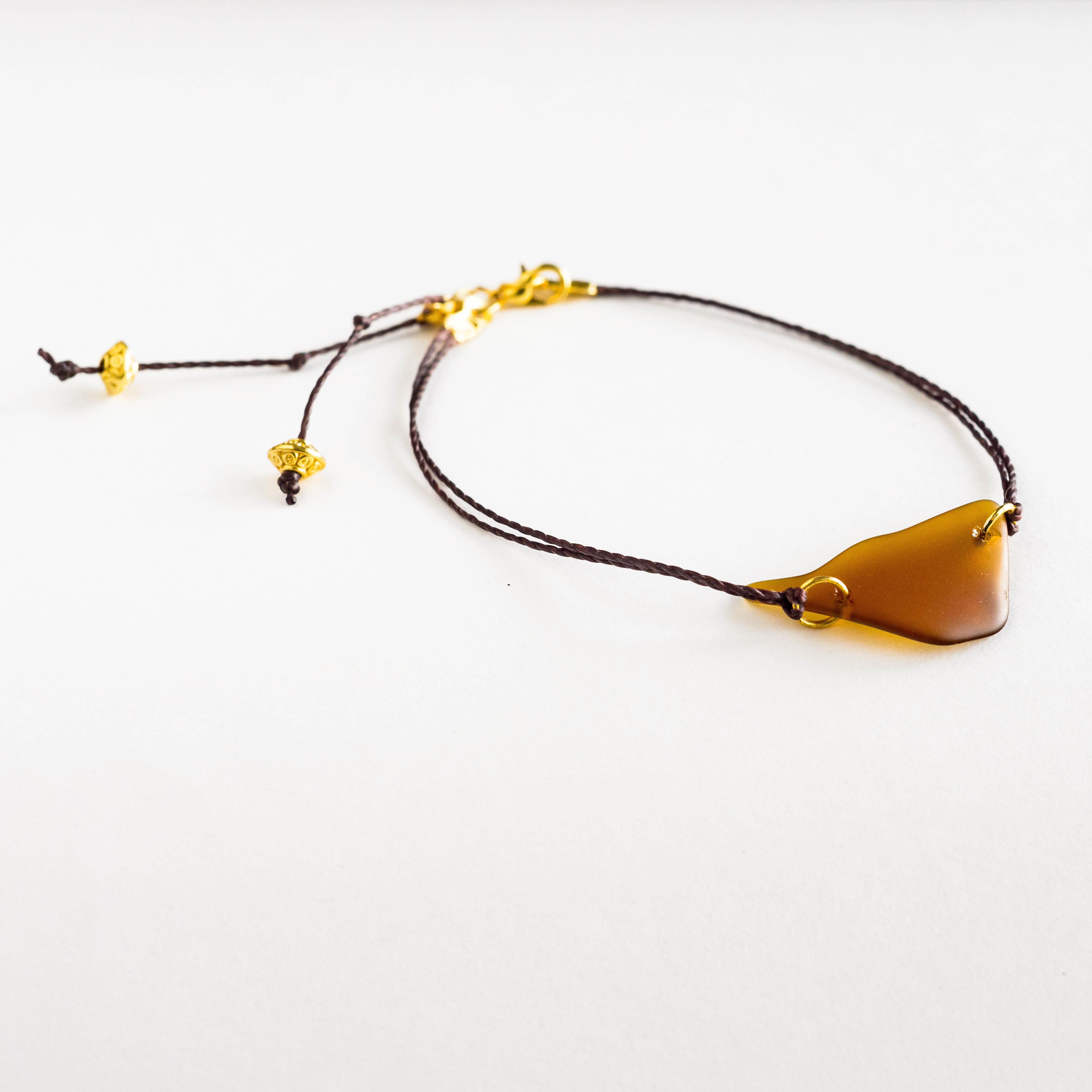 Brown sea glass bracelet with brown cord and gold accent - $18