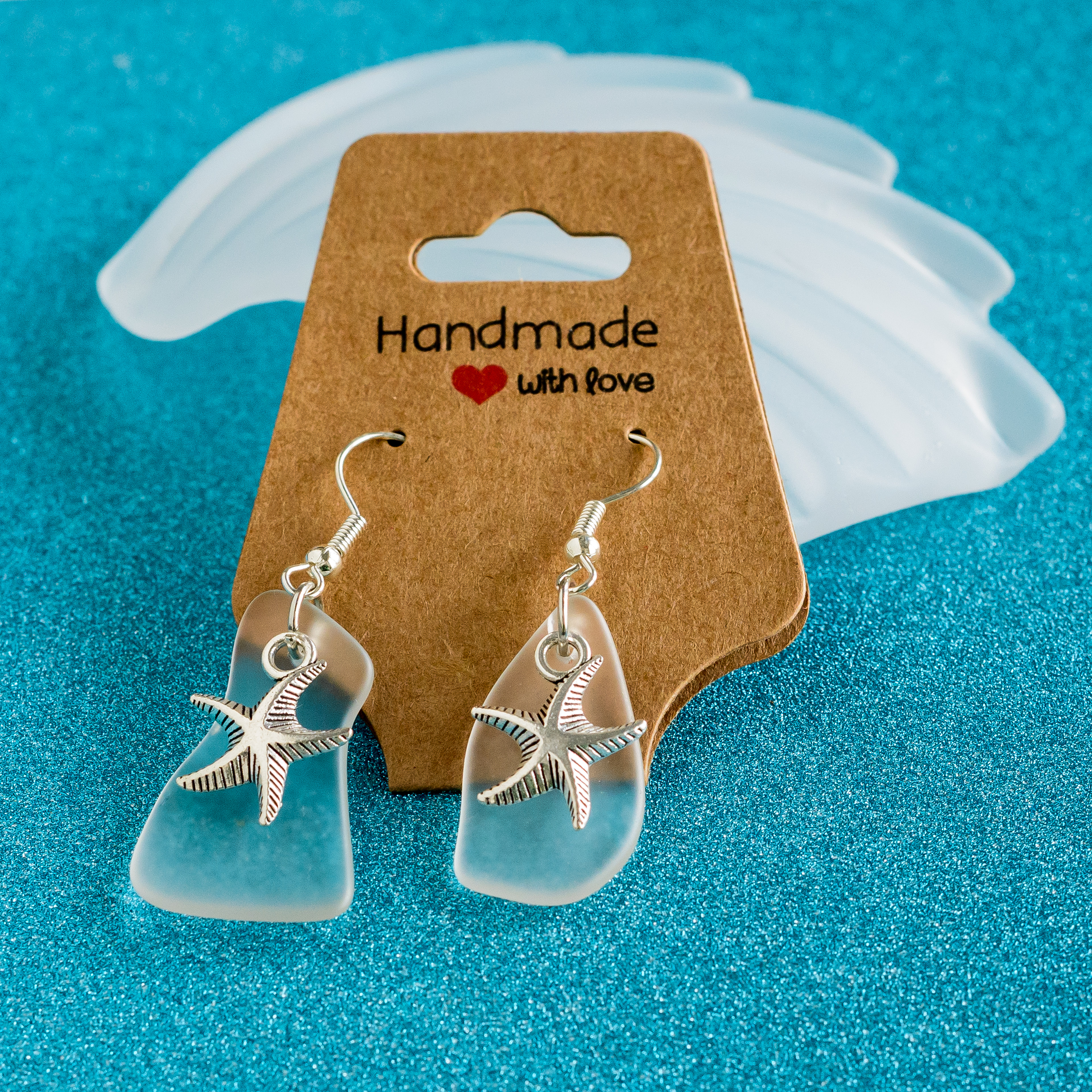 Clear sea glass earrings with star fish silver accent - $24