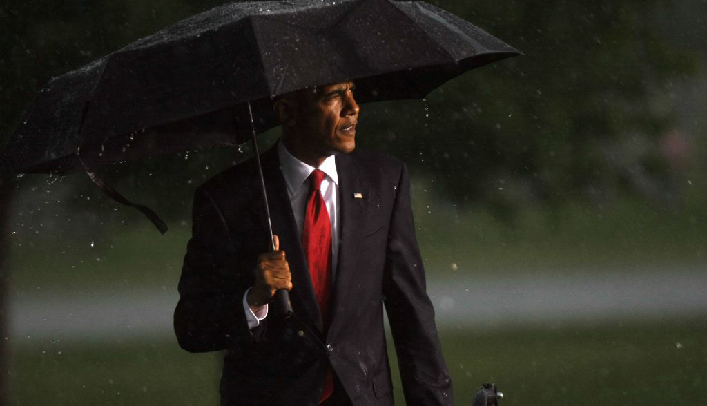 Pres. Barack Obama in a sudden downpour during a Chicago visit. (ChicagoTribune)