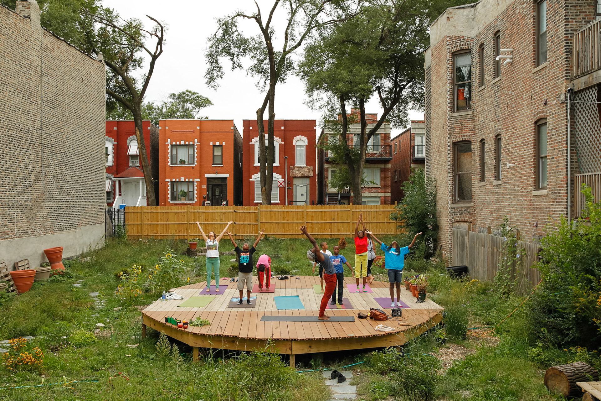 Neighborhood children take part in a yoga class in the Yoga Garden located on Lexington Street west of Washtenaw Avenue.