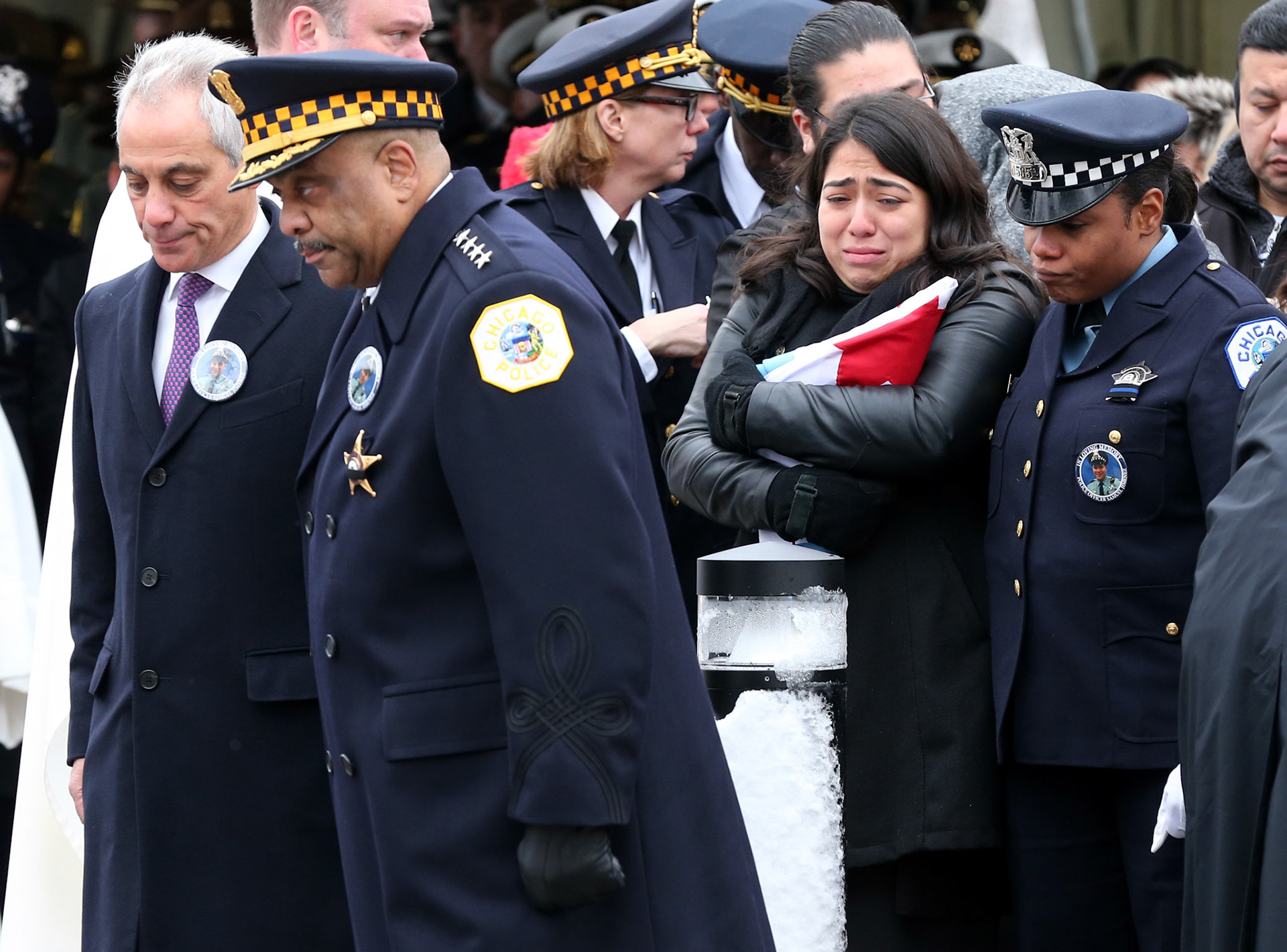 Crystal Garcia, the widow of slain police officer Samuel Jimenez, weeps after being presented the City of Chicago flag from Chicago police Superintendent Eddie Johnson and Mayor Rahm Emanuel. (ChicagoTribune)