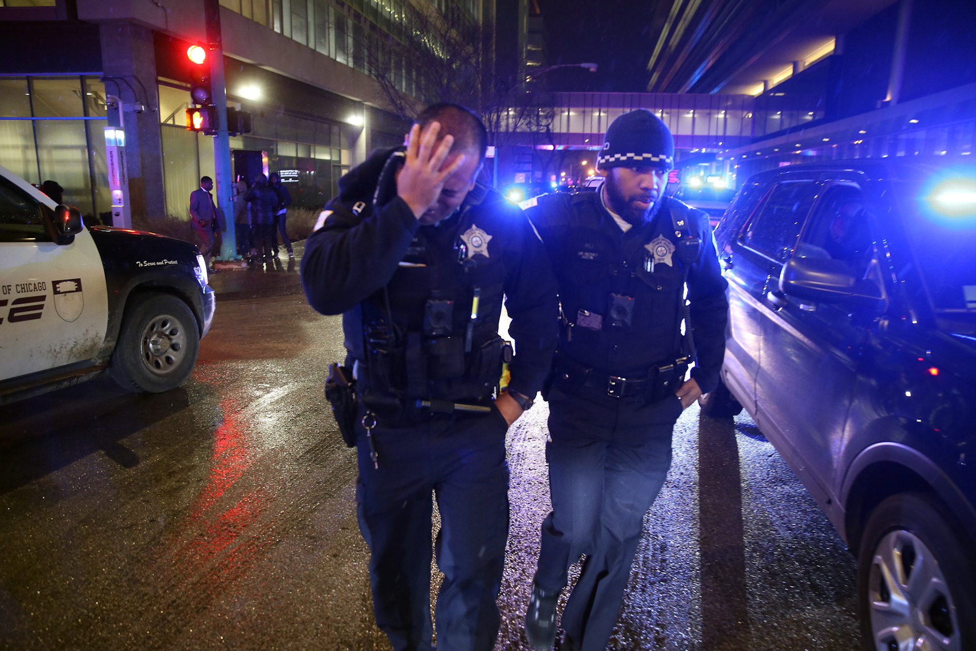 Chicago police comfort one another after honoring Officer Samuel Jimenez, who was shot and killed nearby. (ChicagoTribune)