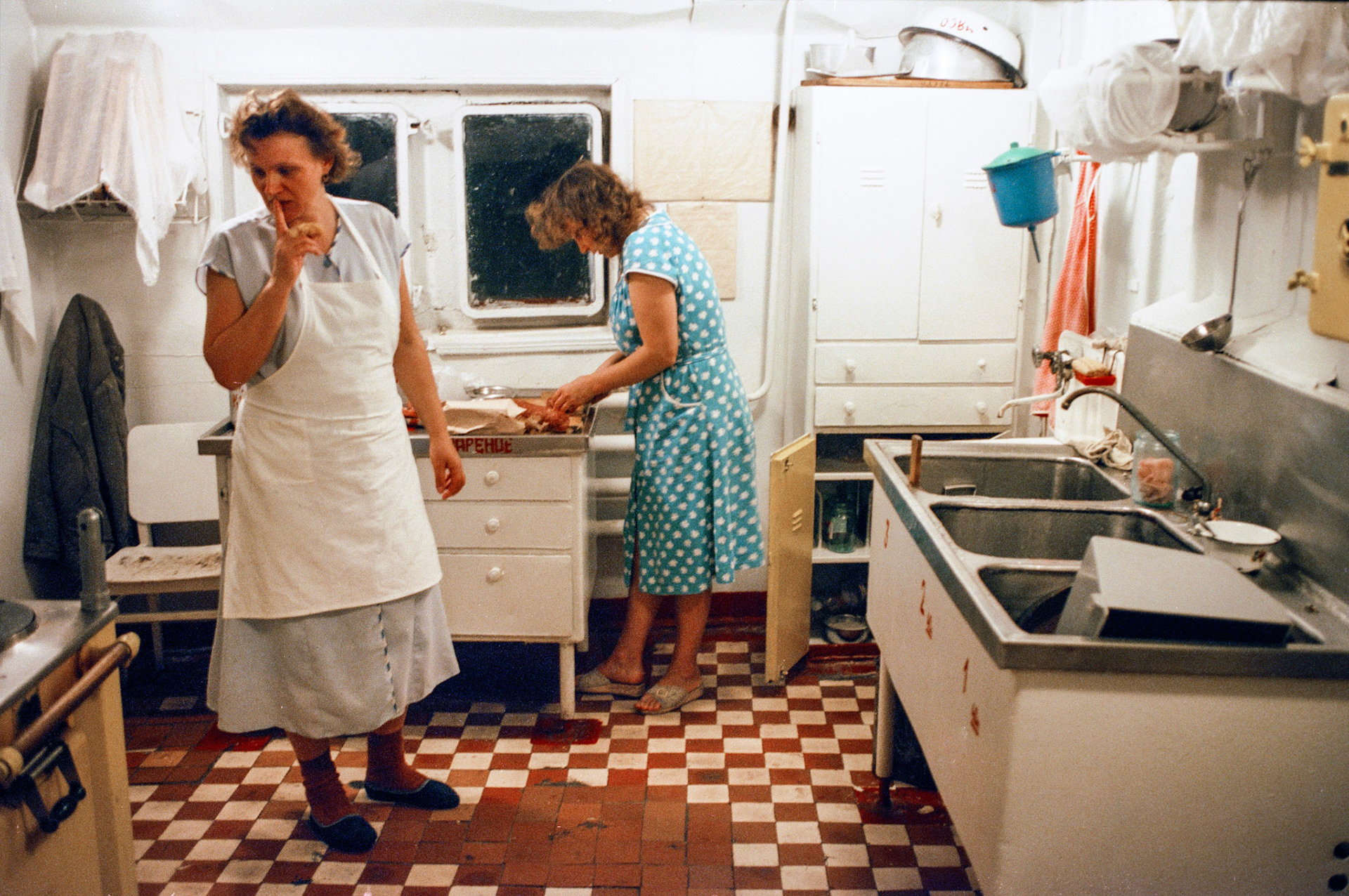 Cooks preparing dinner for shipmates in the galley aboard a freighter on the Volga River.