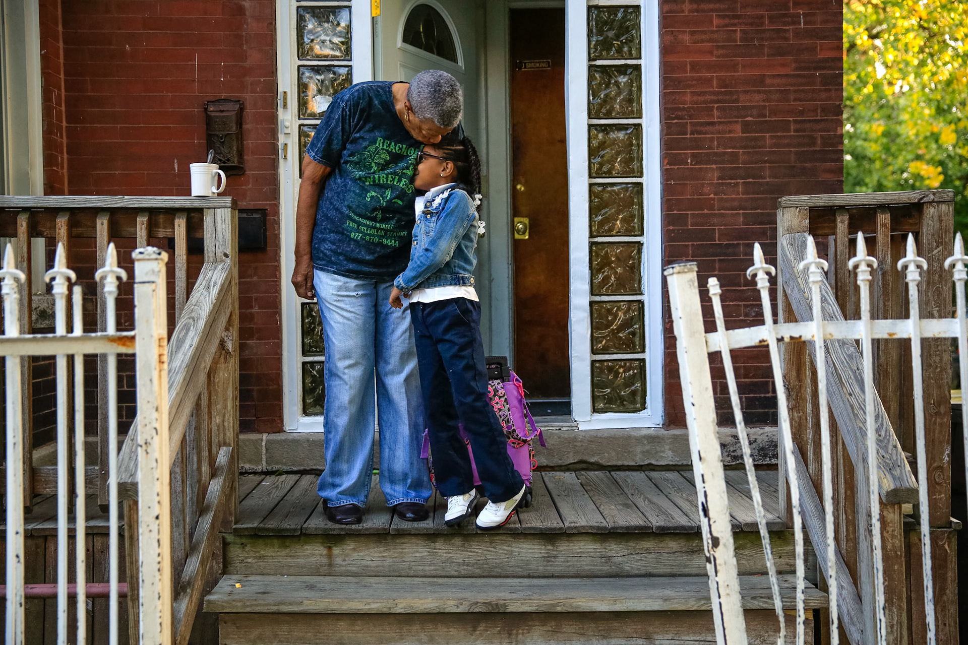 Ethel Milton, 79, kisses her granddaughter Jayla McCallum, 7, before sending her off to school.