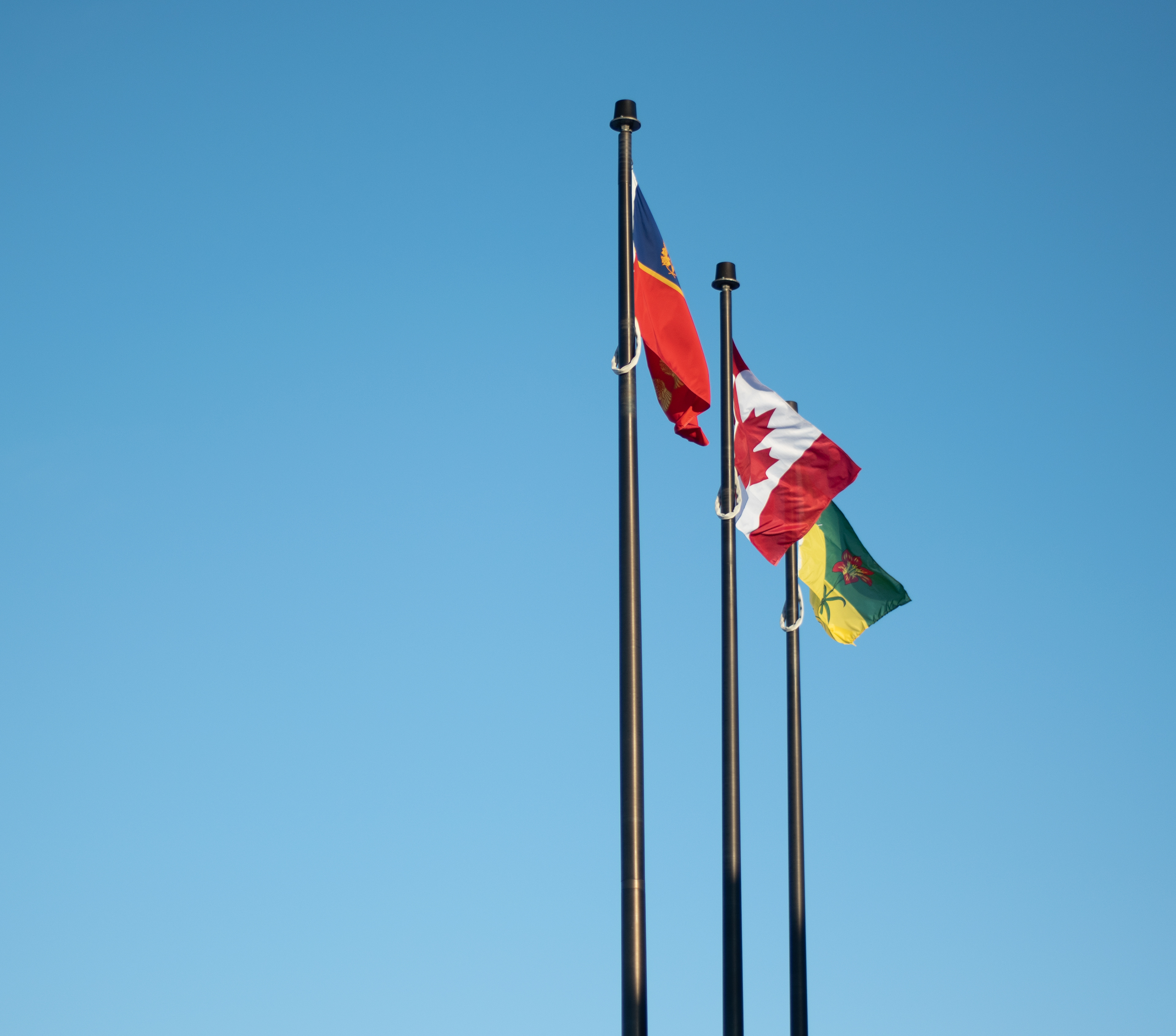 The three flags that stand in front of the Rcmp headquarters building in Regina