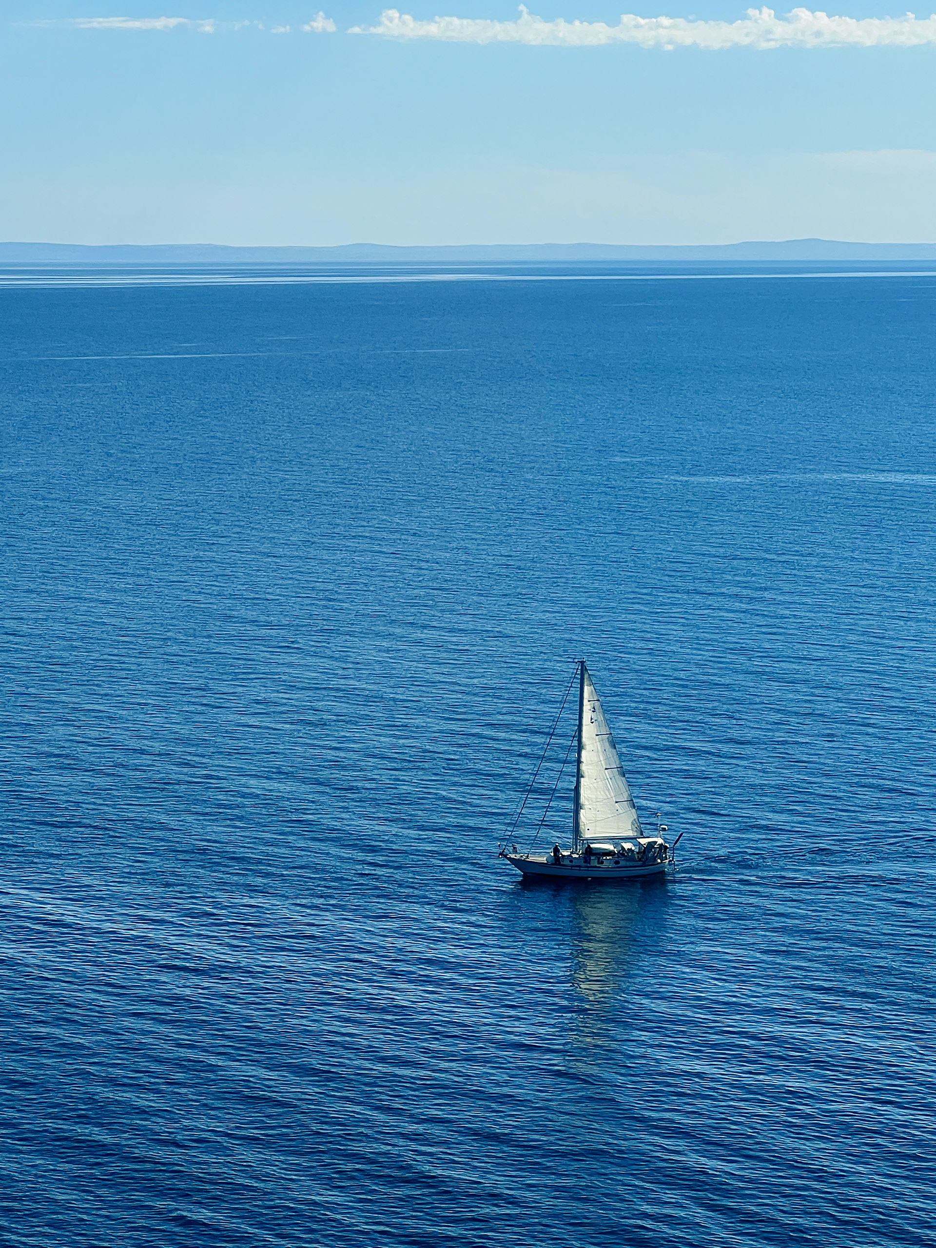 Photo was taken overlooking Split Rock Lighthouse in Duluth, Minnesota. I love the lonely feeling of the sailboat on the vast Lake Superior