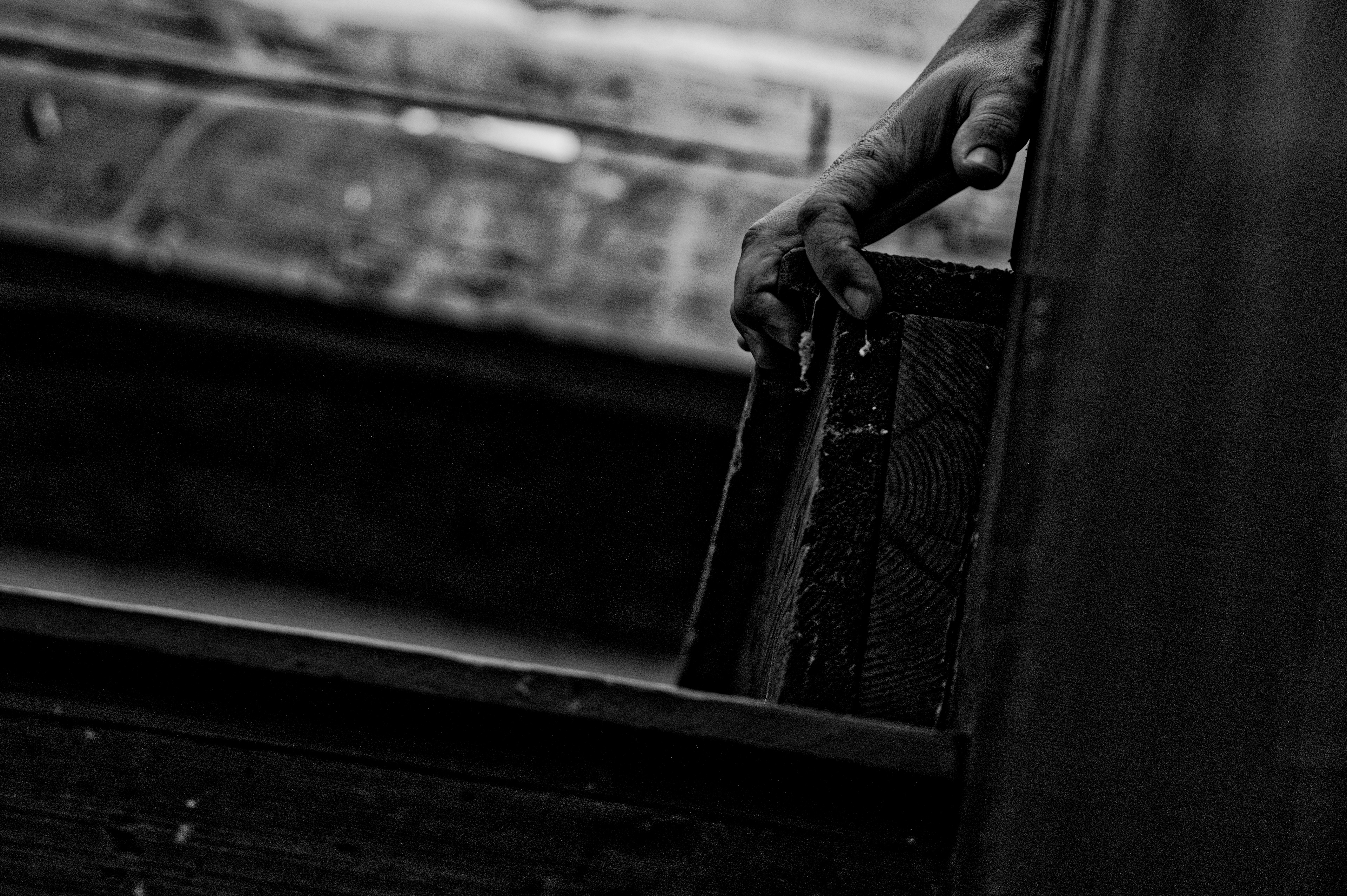 Holding on, though the world moves past. A grip on something solid in a place long forgotten. The weight of history in the palm of a hand.