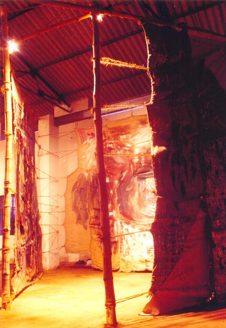 Raghavendra Rao, Size:  10ft x 10ft x 10ft, Medium:  gunny cloth, bamboo poles,  coconut fibre ropes,  photographs and paint.