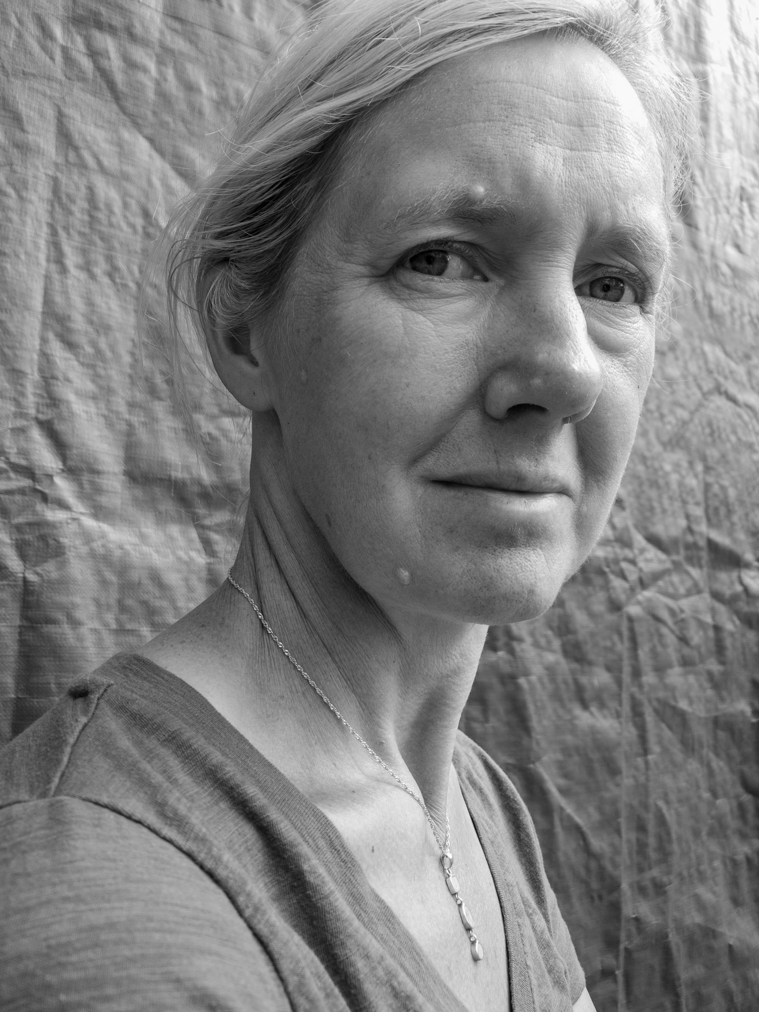 Joanne Smith photographer with a plain background