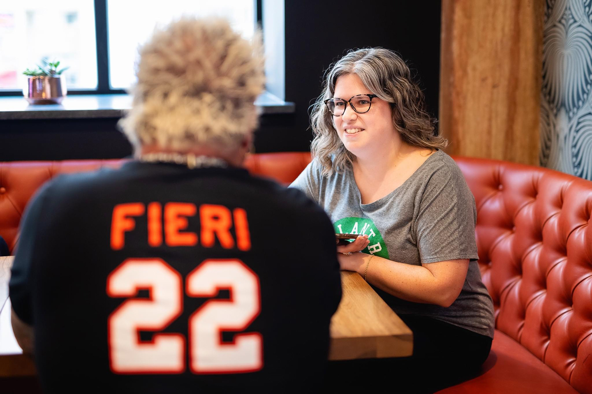 Guy Fieri speaking with a local Boston reporter in his newest Boston restaurant