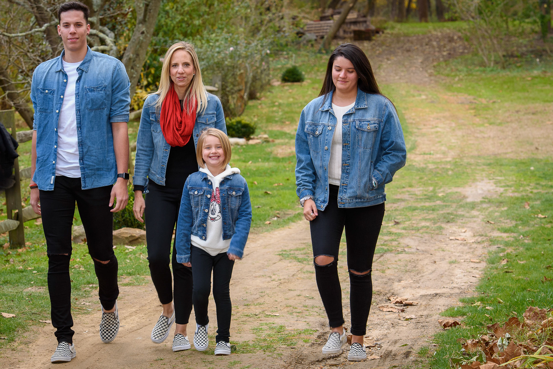 Family walking towards photographer in a park