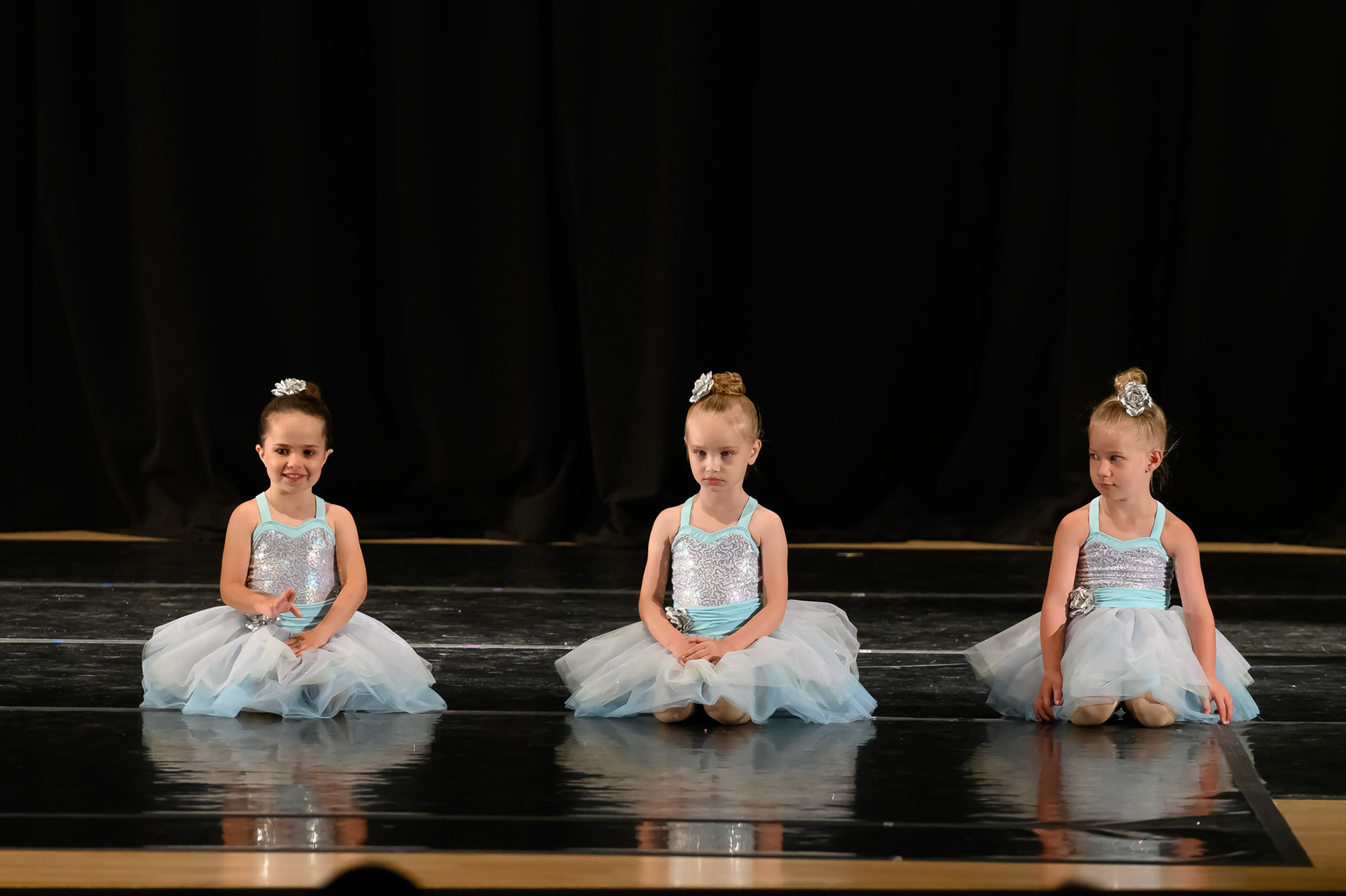 Young dancers posing and waiting to start their performance during a Recital of Illumination Dance