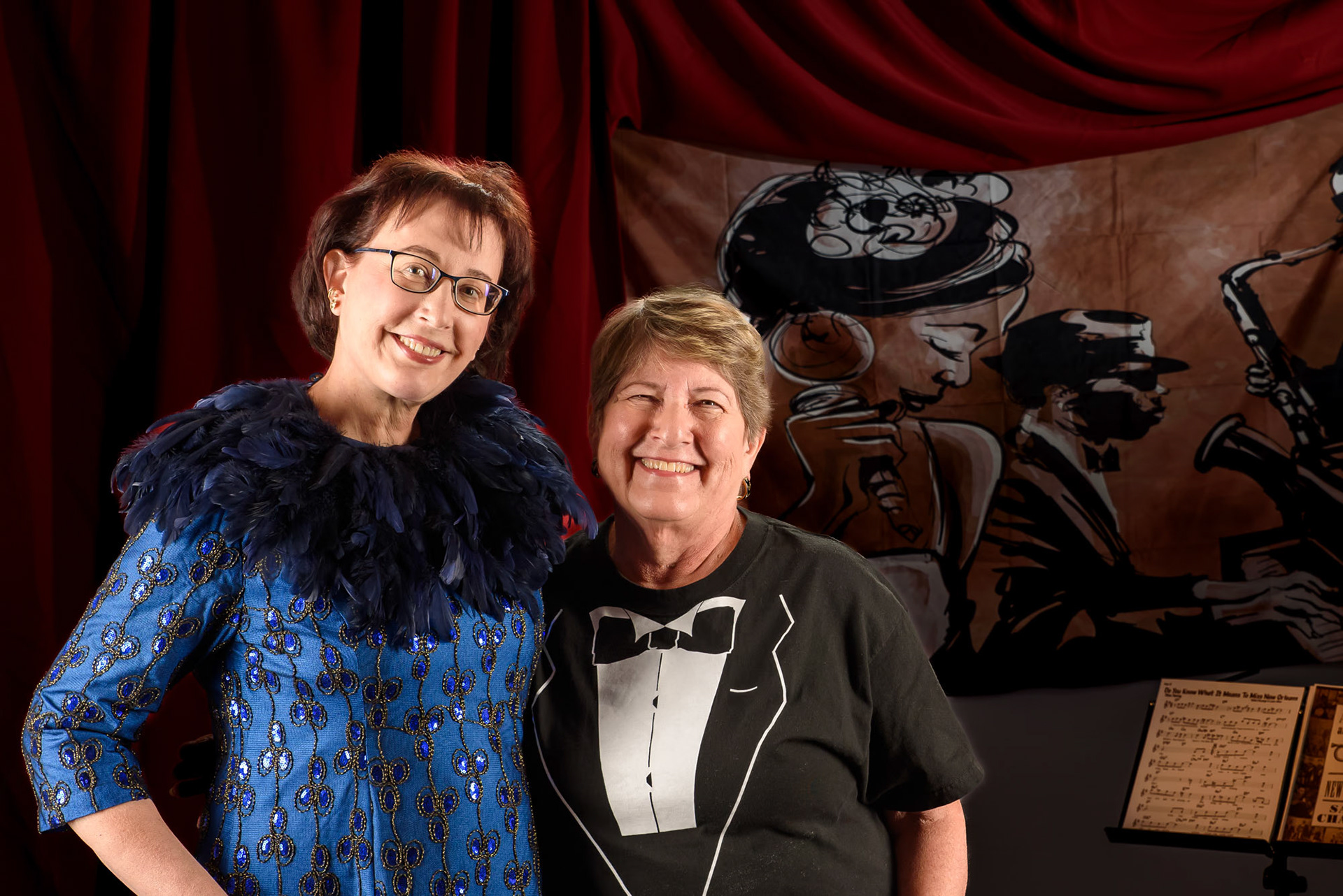 Two woman anjoying a jazz theme event. Photo in a studio like environment.