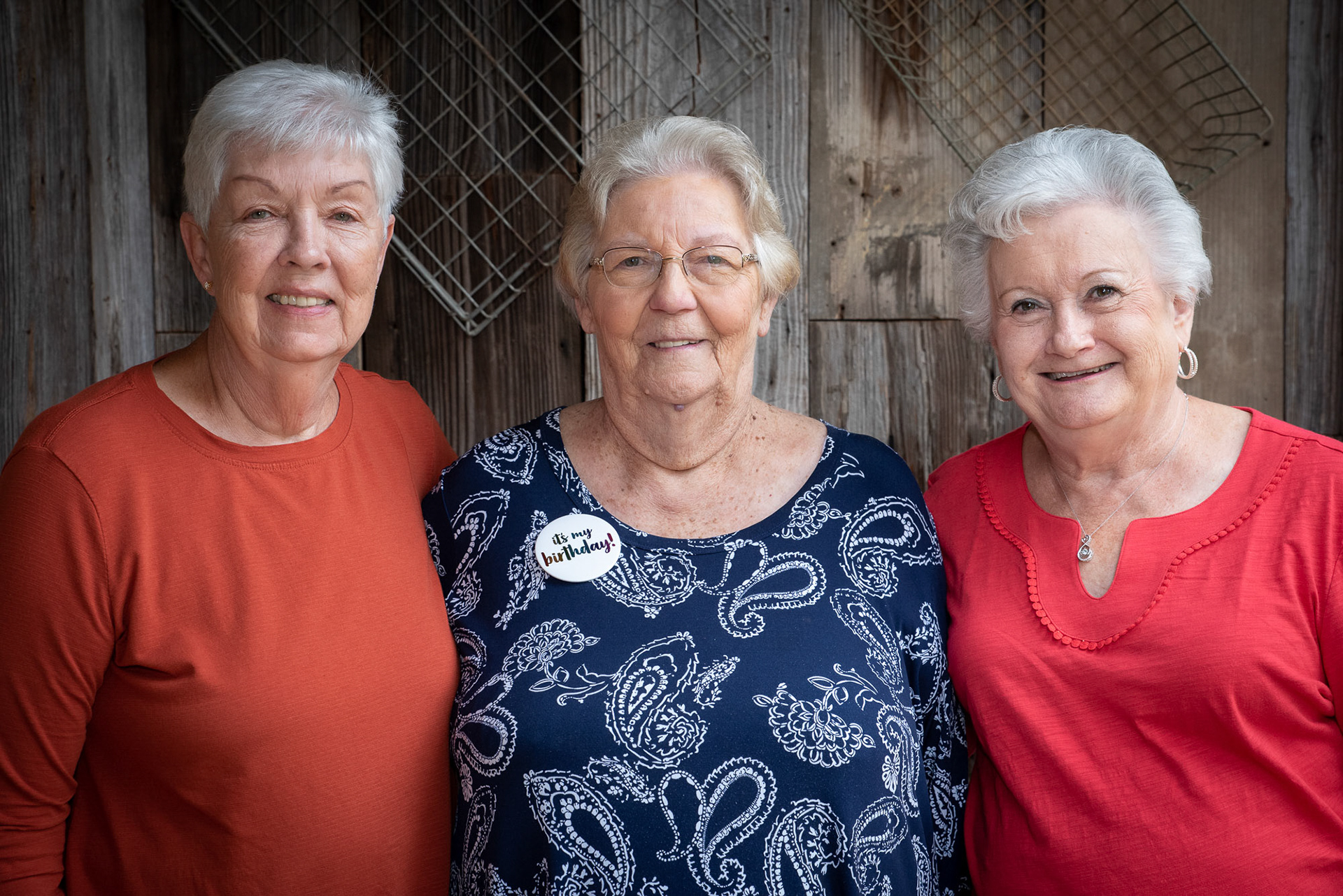 Three mature woman in a group photo