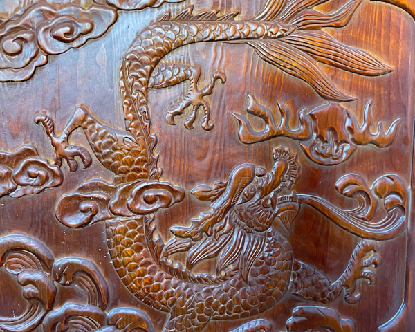 Dragon carved out of wood on bathroom door